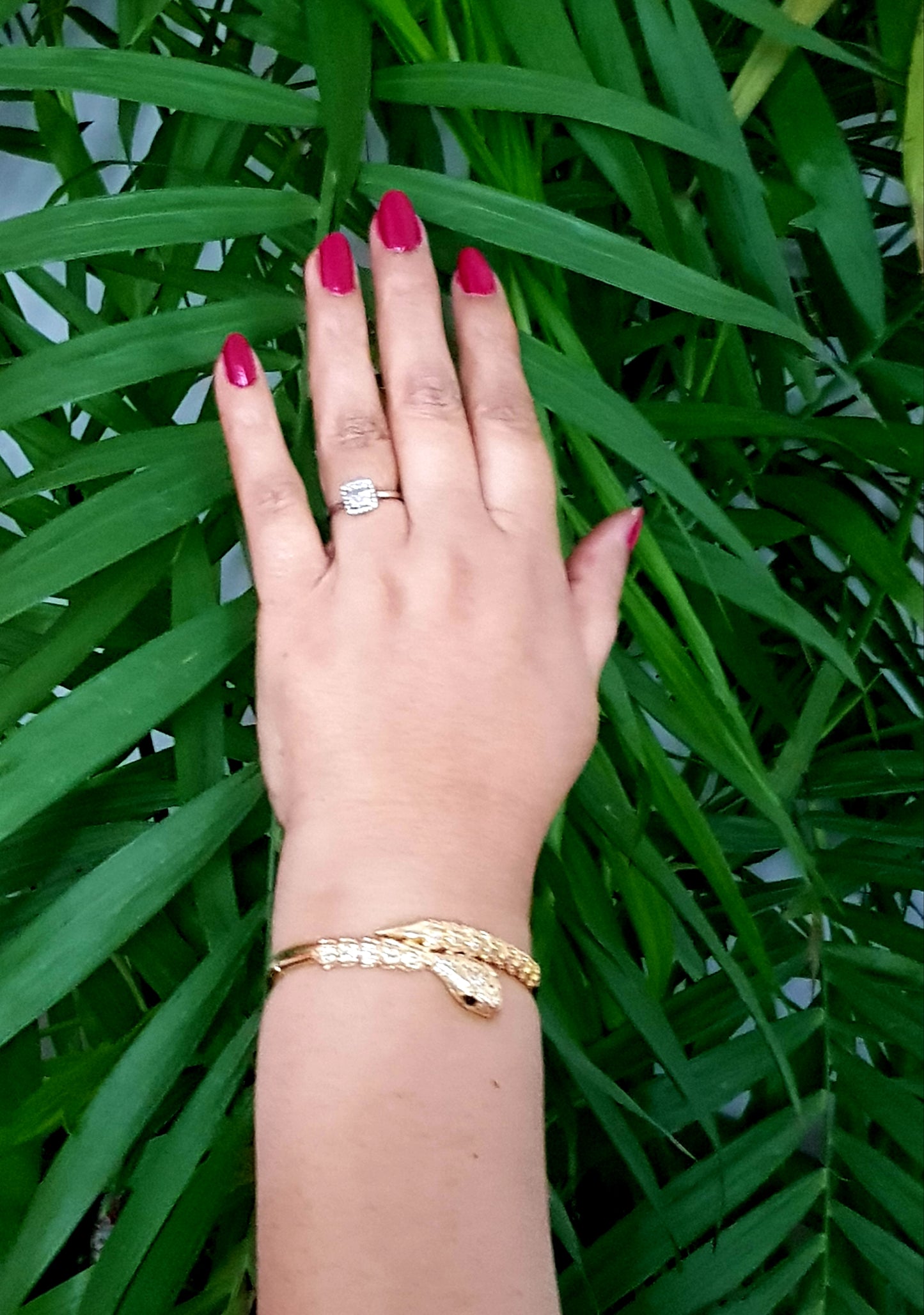 Snake shaped gold finish bracelet with emerald stone eye, embellished with CZ