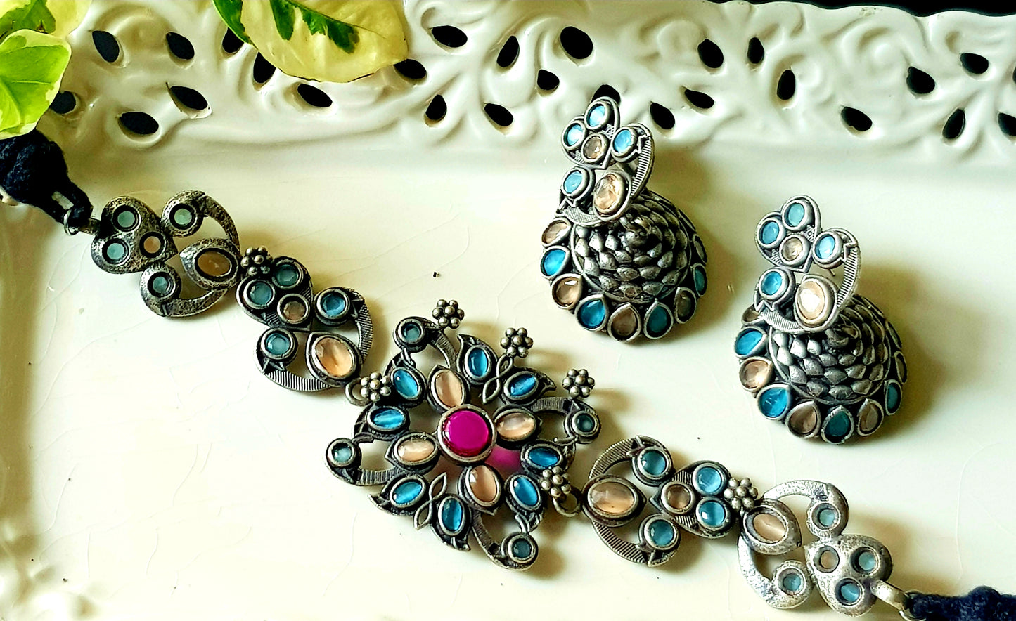 Antique silver finish choker set with pale peach, pale blue stone, matching jhumka (earrings)