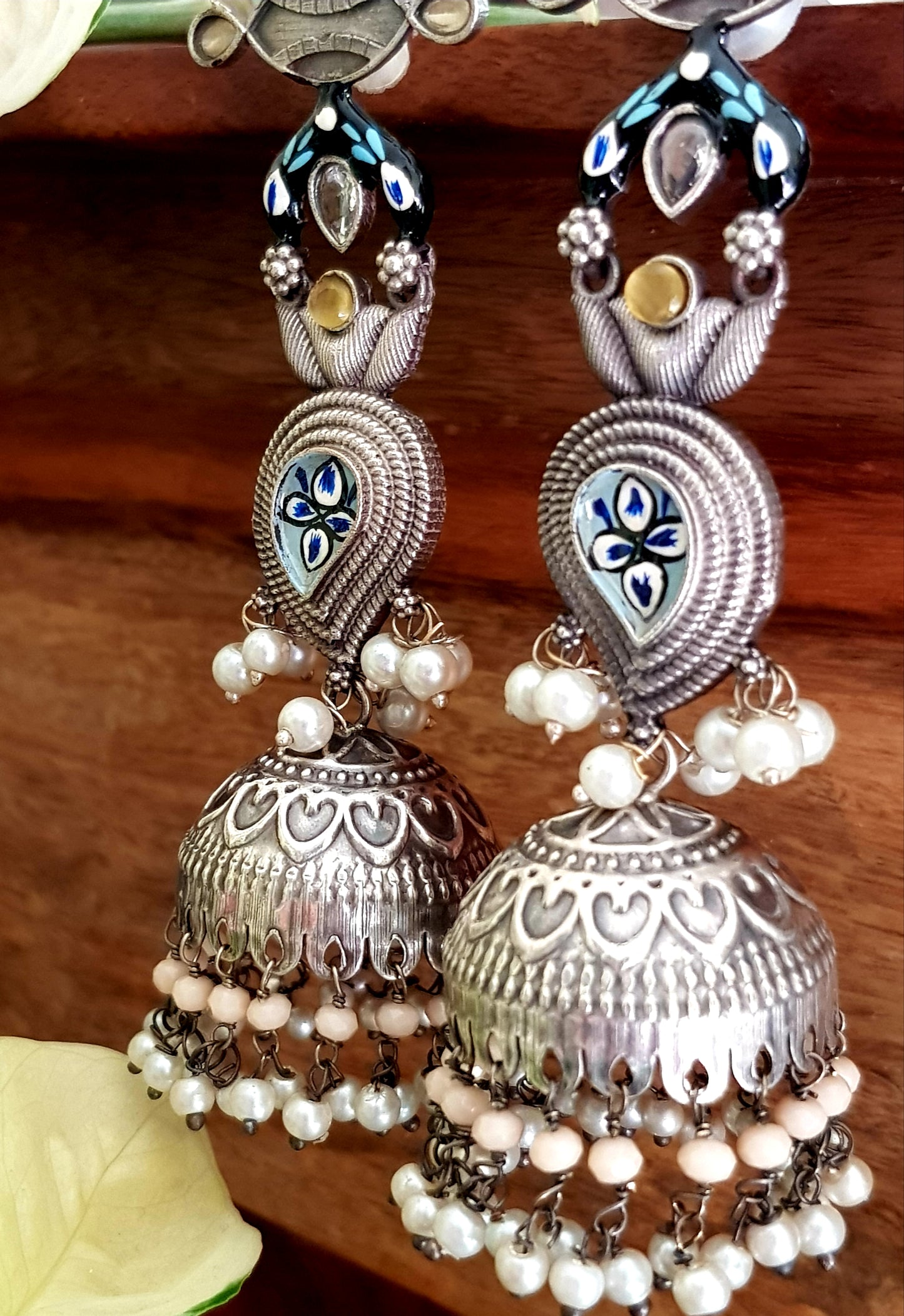Silver finish jhumka (earrings) with handpainted paisely piece and studs, embellished with stones