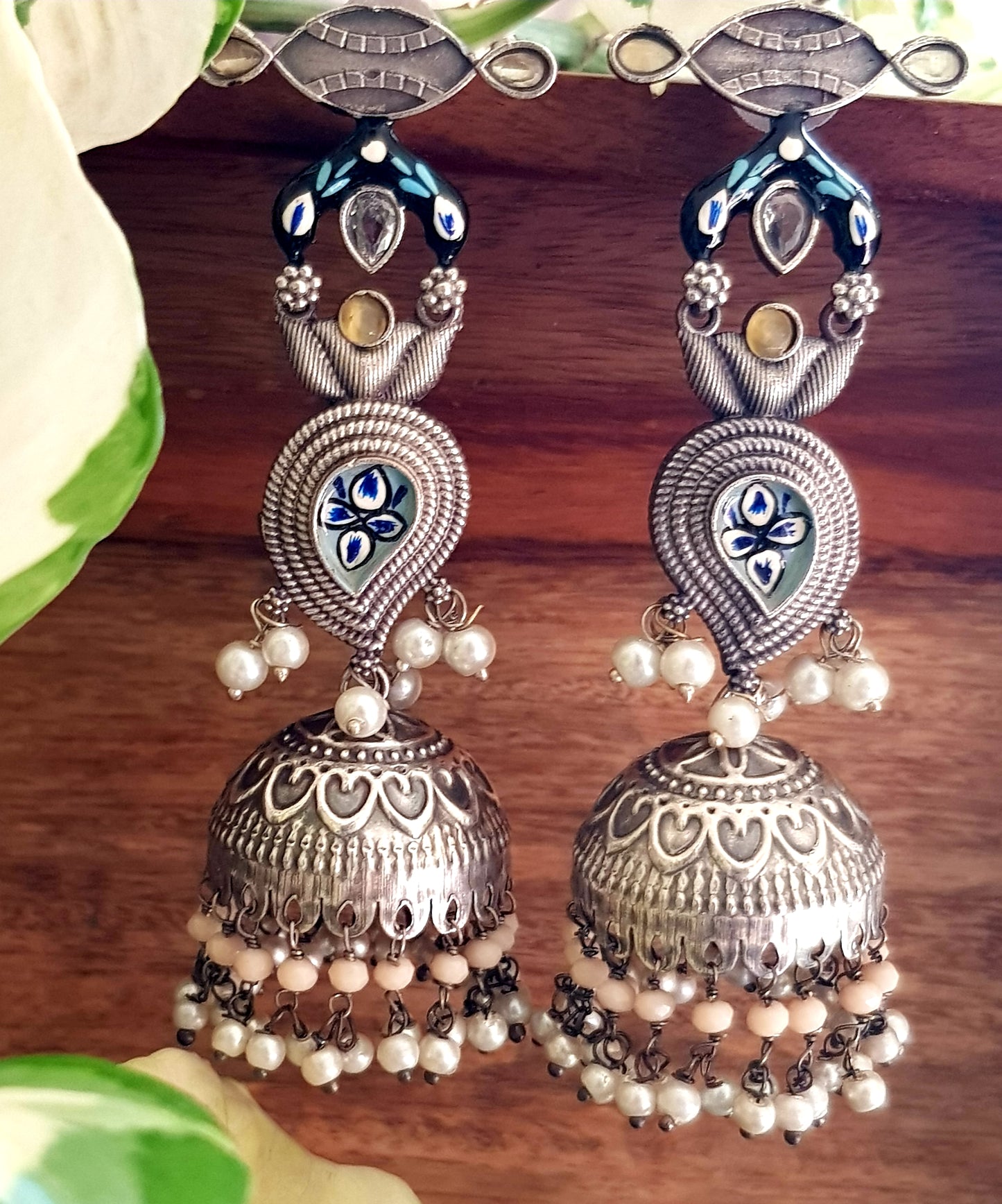 Silver finish jhumka (earrings) with handpainted paisely piece and studs, embellished with stones
