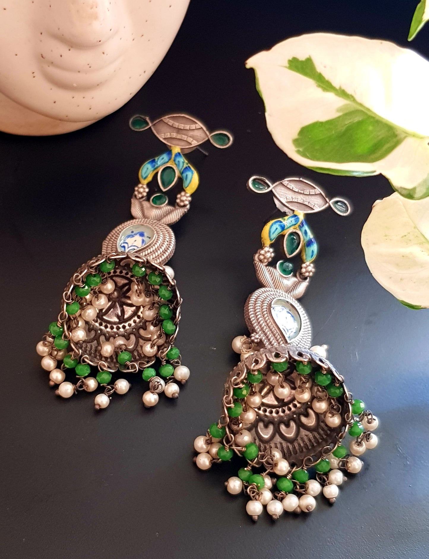 Silver finish jhumka (earrings) with handpainted paisely piece and studs, embellished with stones