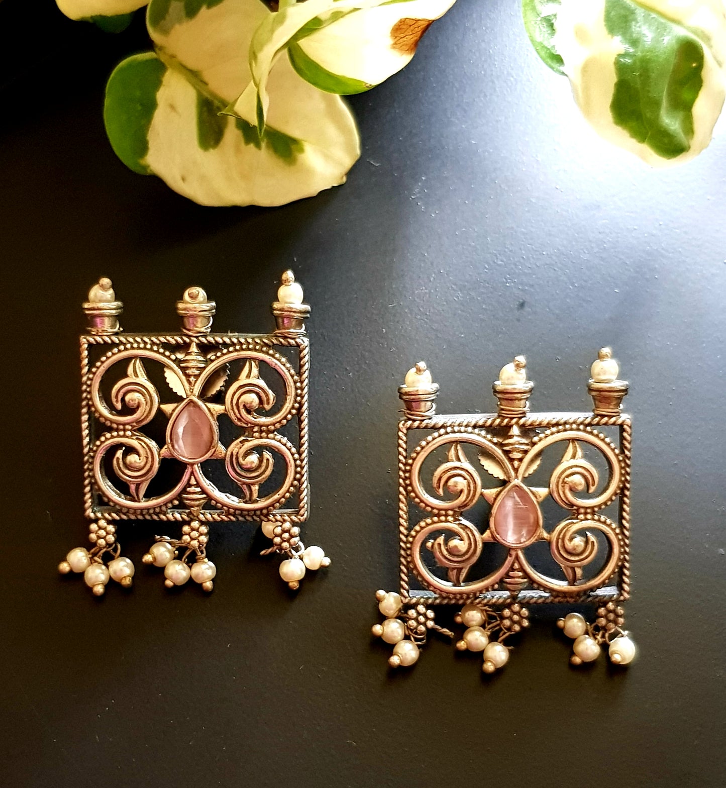 Dual tone set with two curved knives below circular clear stone and square jaali pieces, matching studs (earrings)