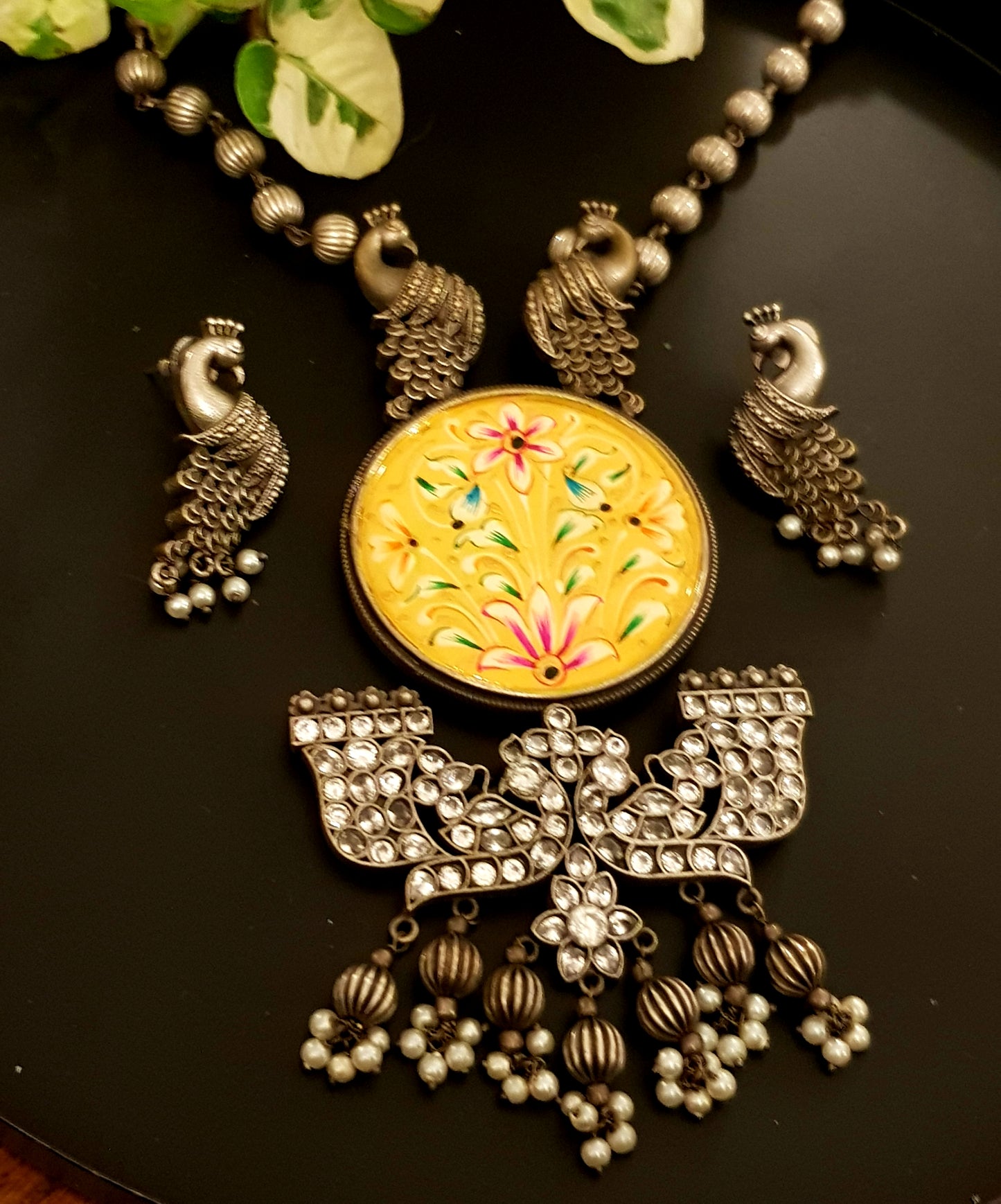 Silver finish hand-painted set with big yellow pendant and peacock motif , matching earrings
