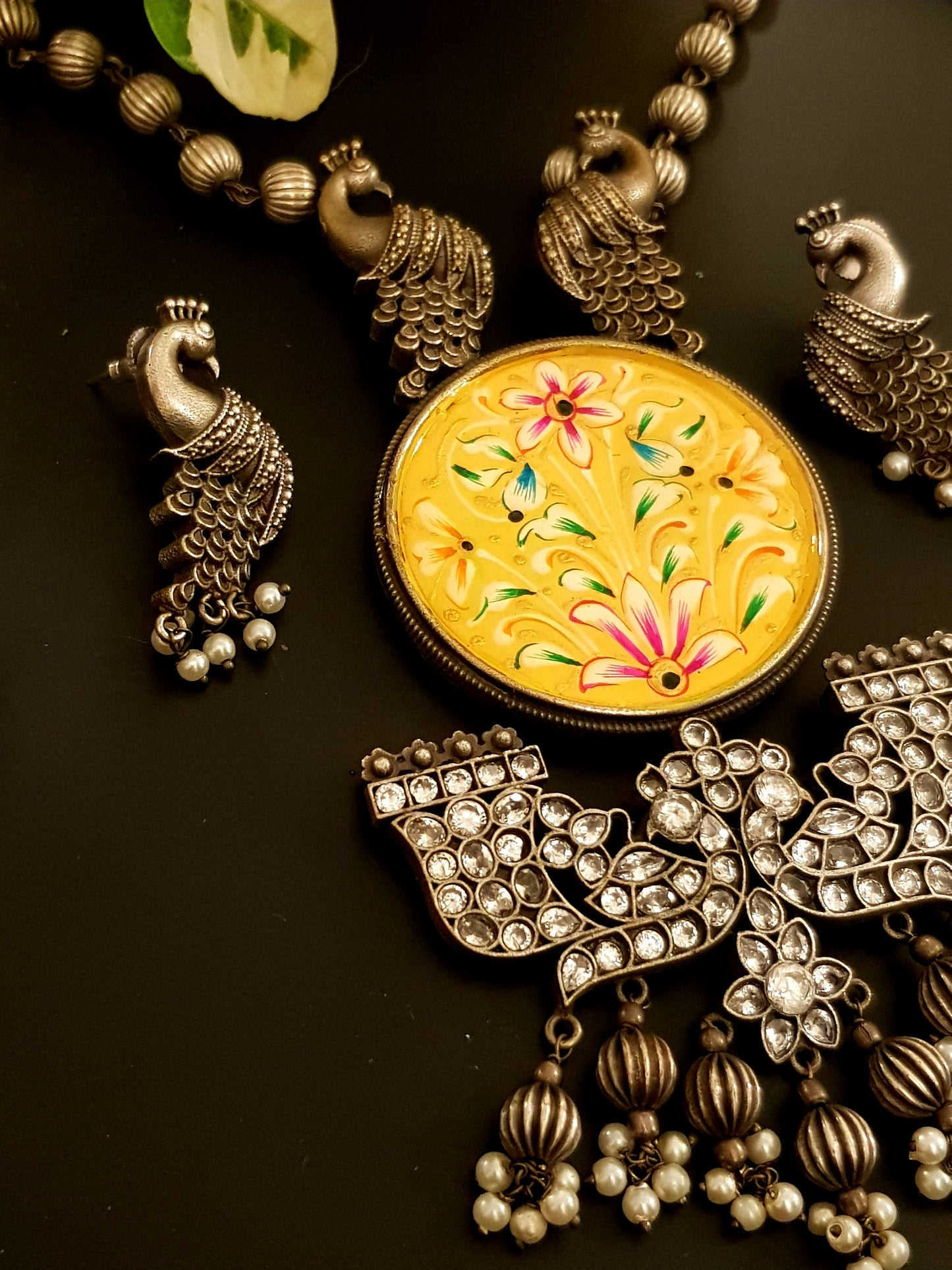Silver finish hand-painted set with big yellow pendant and peacock motif , matching earrings