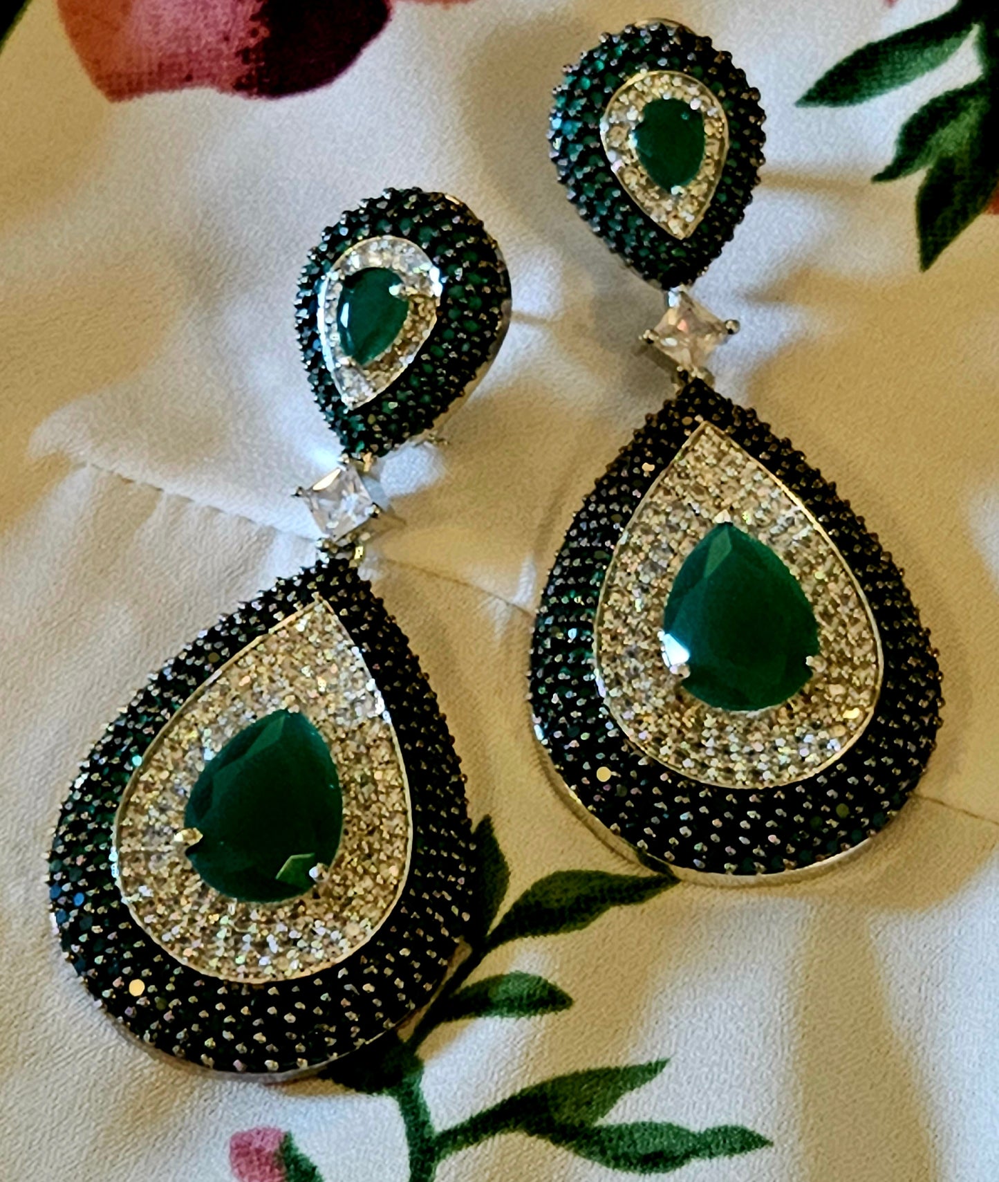 Platinum finish danglers (earrings), big teardrop shape with emerald/ruby and clear stone piece hanging under matching stud