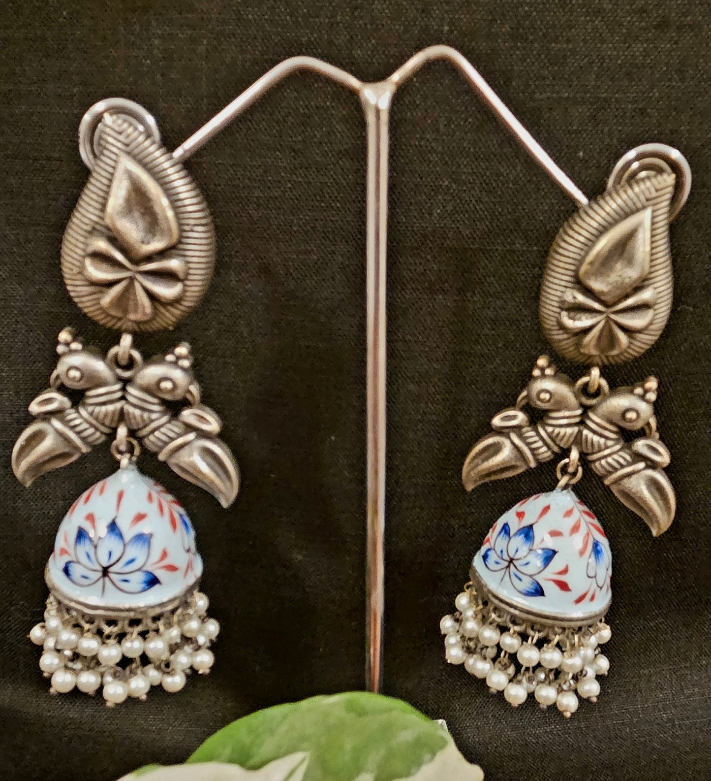 Silver finish hand painted jhumka (earrings) with paisley stud and parrot motif
