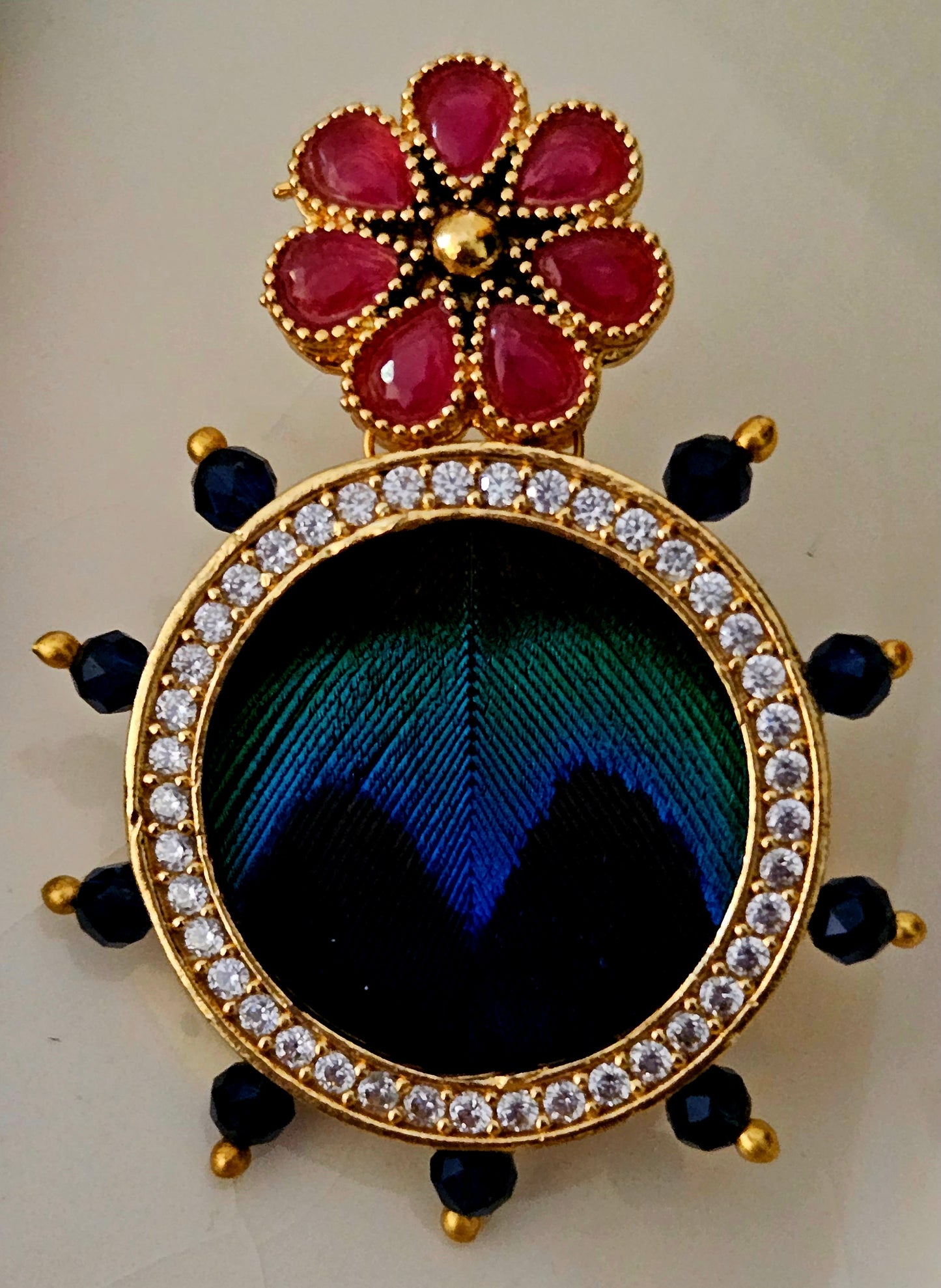 Pendant set with morpankh pendant framed with flower design in pearl and bead necklace, matching studs (earrings)