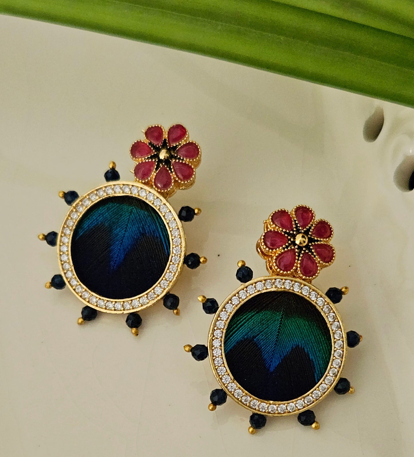 Pendant set with morpankh pendant framed with flower design in pearl and bead necklace, matching studs (earrings)