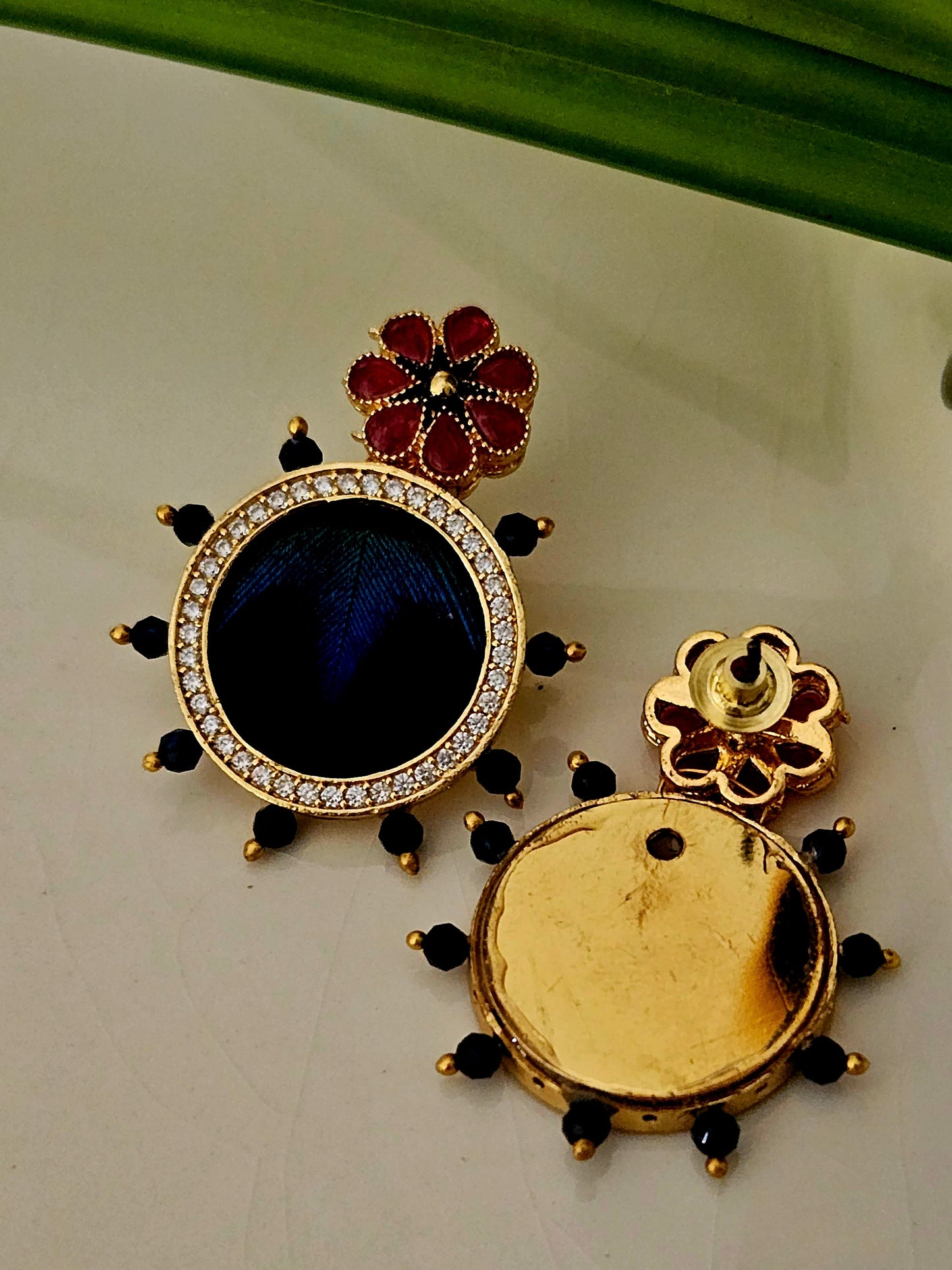 Pendant set with morpankh pendant framed with flower design in pearl and bead necklace, matching studs (earrings)