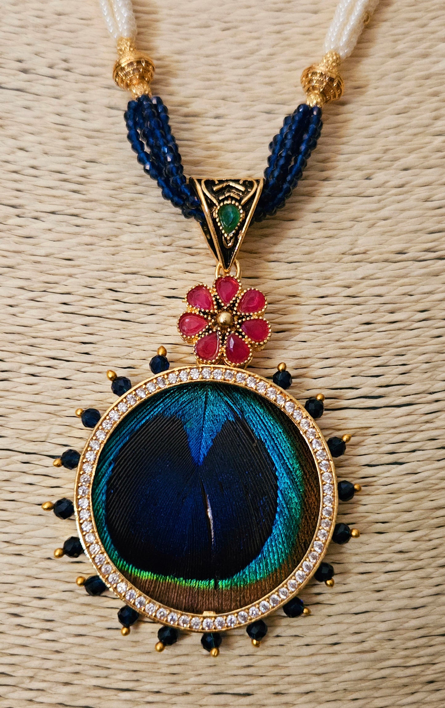 Pendant set with morpankh pendant framed with flower design in pearl and bead necklace, matching studs (earrings)