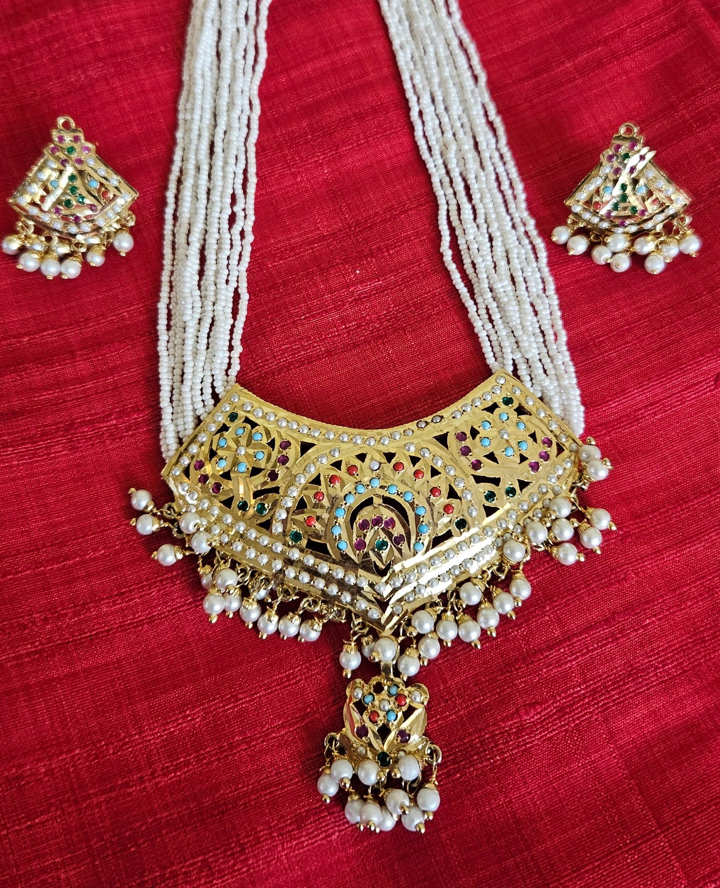 'Virtuous white' gold finish jadau set with navratan/pearl inlaid long necklace and matching earrings