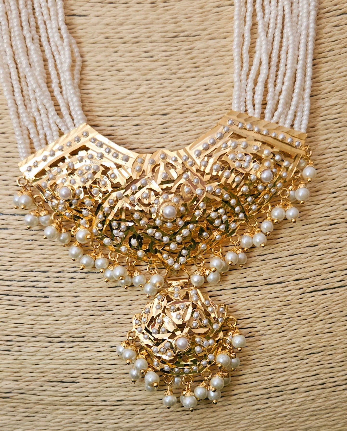 'Virtuous white' gold finish jadau set with navratan/pearl inlaid long necklace and matching earrings
