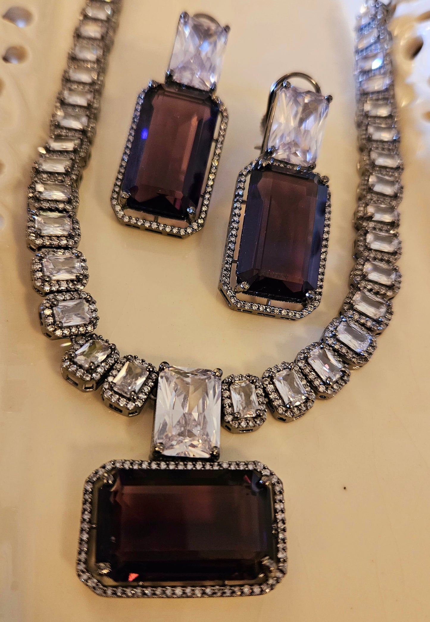 Antique platinum finish set, square single strand clear stone necklace with topaz/purple/light blue pendant with CZ accents allover, matching earrings