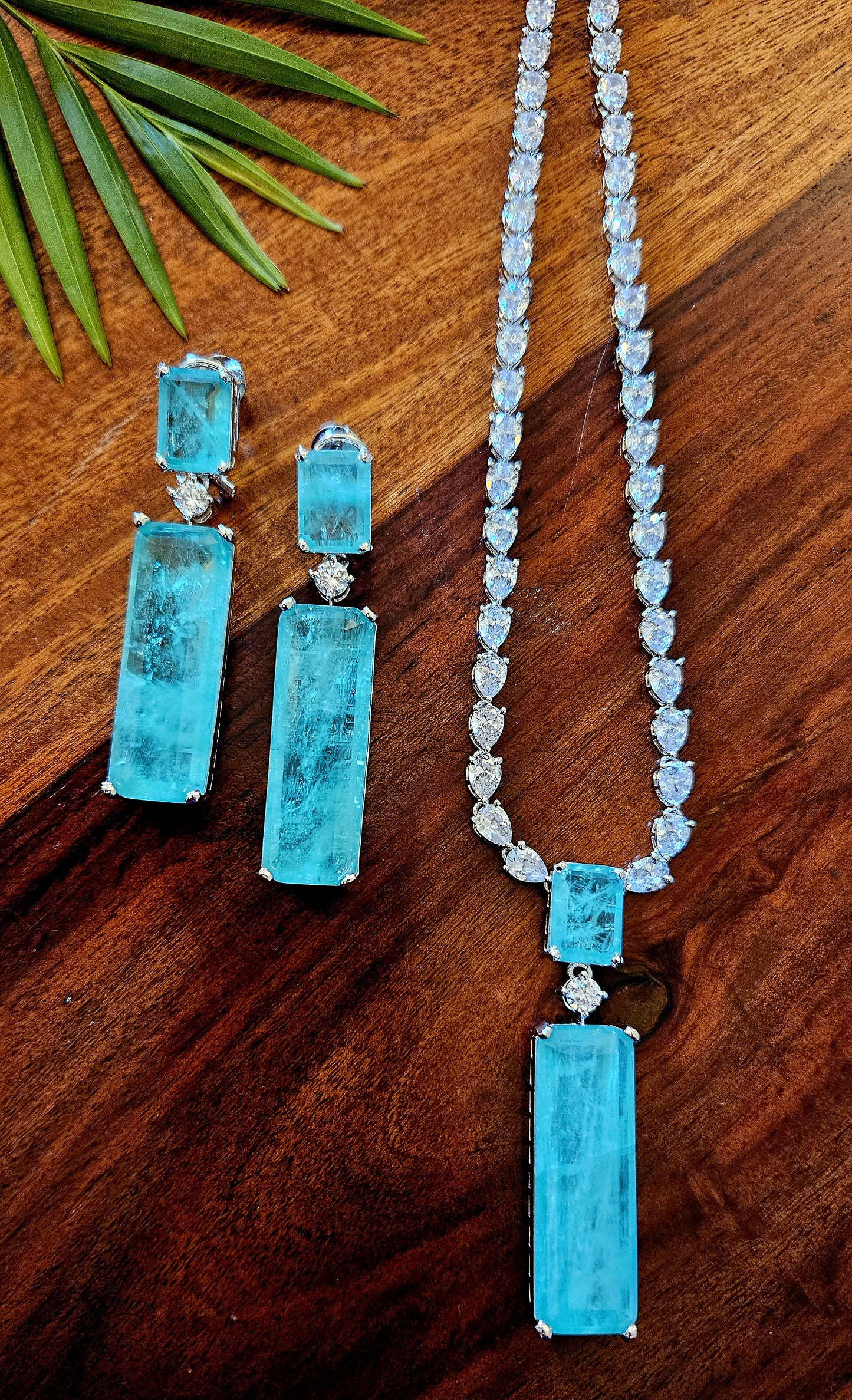 Platinum finish set with long mint green stone pendant in CZ single layer strand, matching earrings