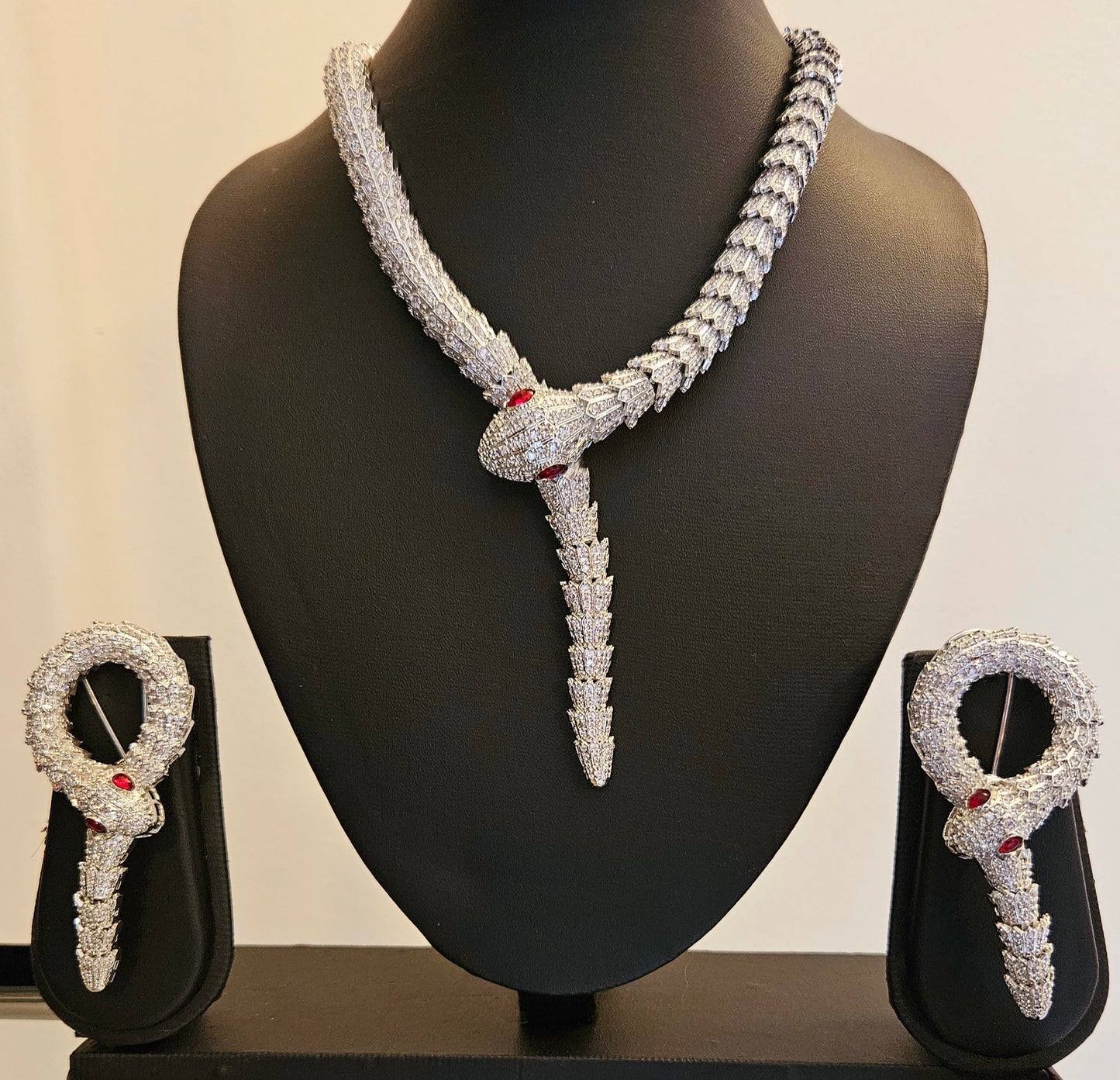 Platinum finish serpent set, necklace has big serpent eye, matching earrings