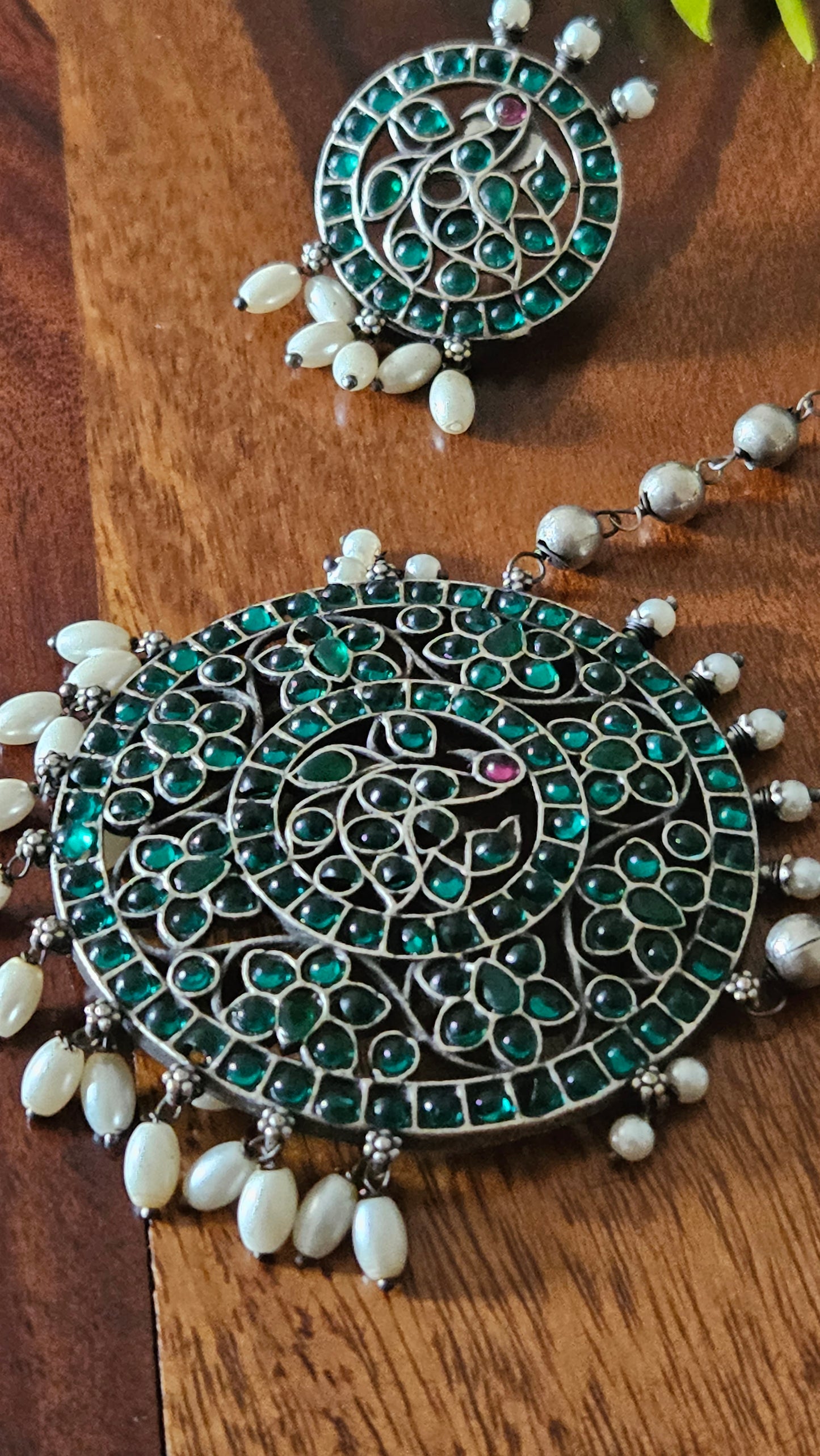 Silver finish long necklace set with big round pendant embellished with green/red stones, matching studs (earrings)