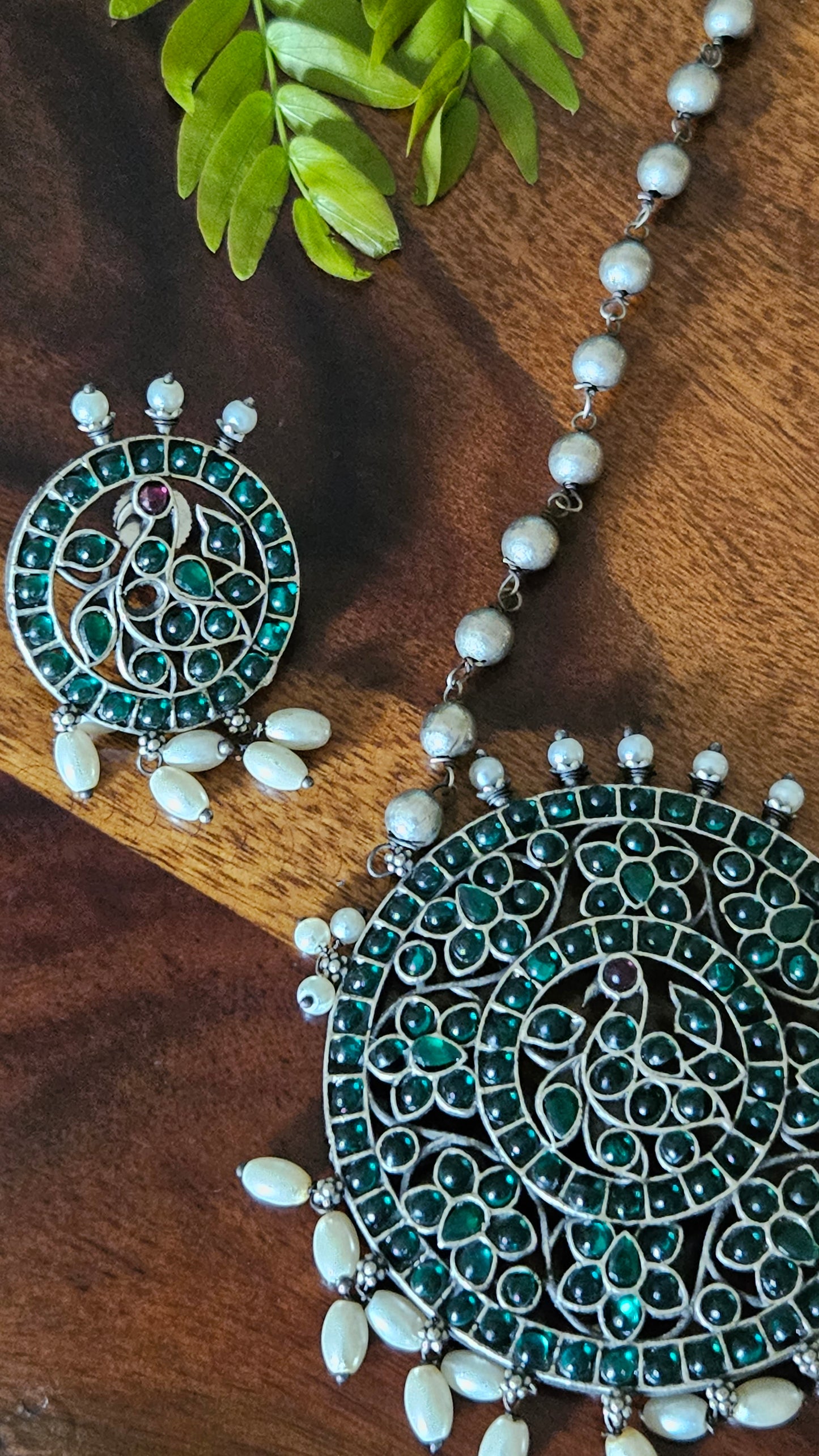 Silver finish long necklace set with big round pendant embellished with green/red stones, matching studs (earrings)