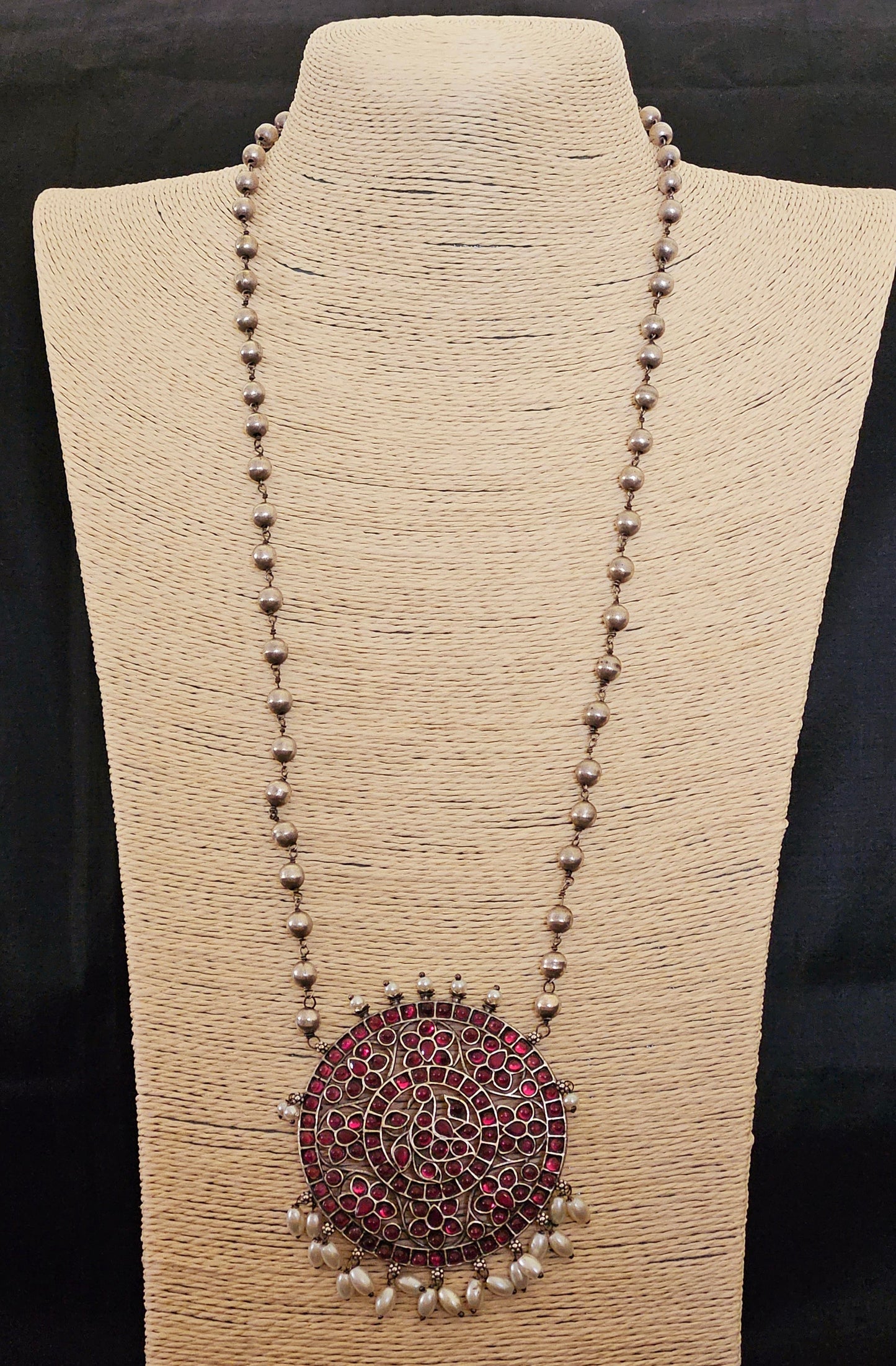 Silver finish long necklace set with big round pendant embellished with green/red stones, matching studs (earrings)