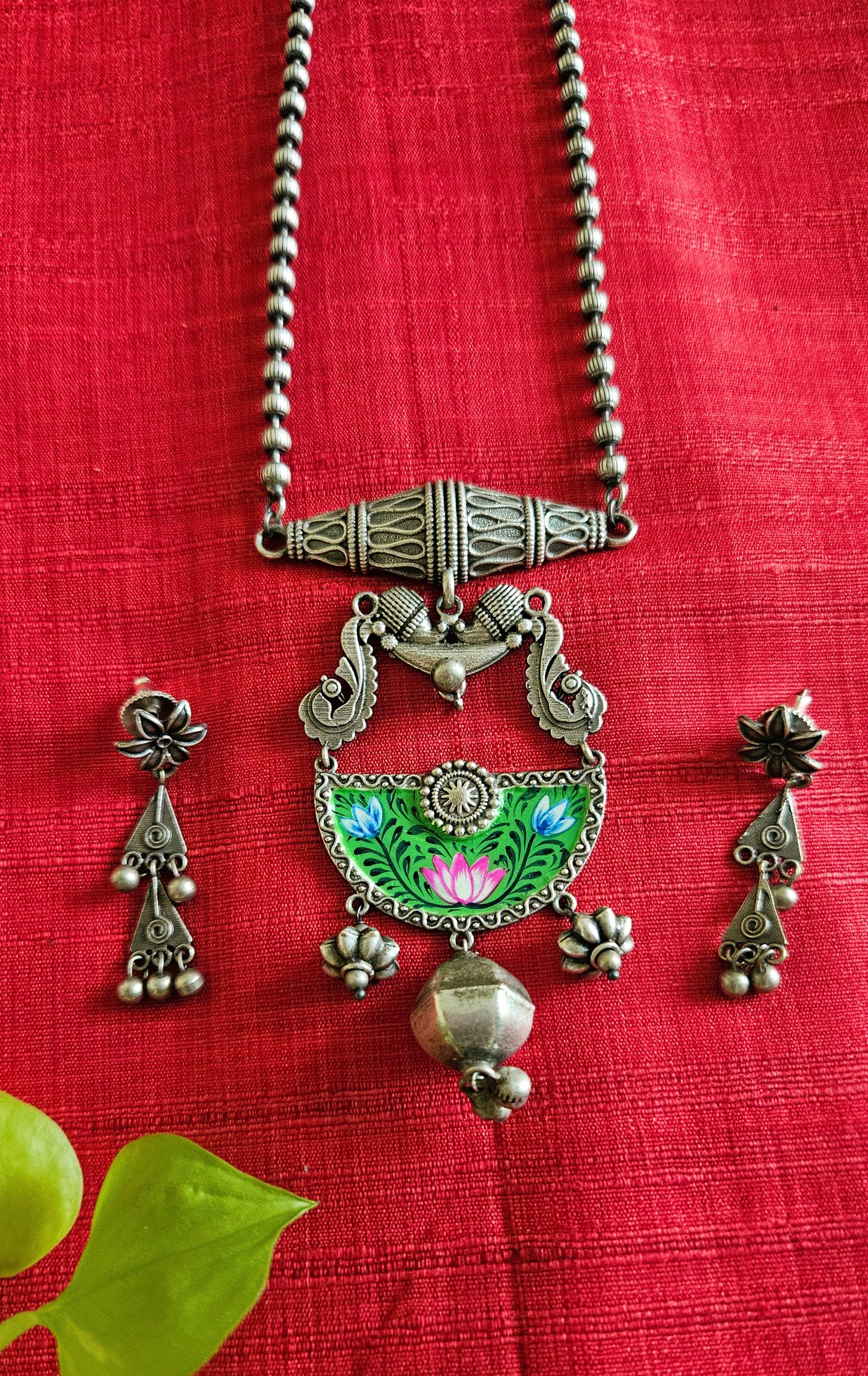 Silver finish long necklace set, green hand-painted pendant with metal globe hanging and damroo held on metal bead chain, matching earrings
