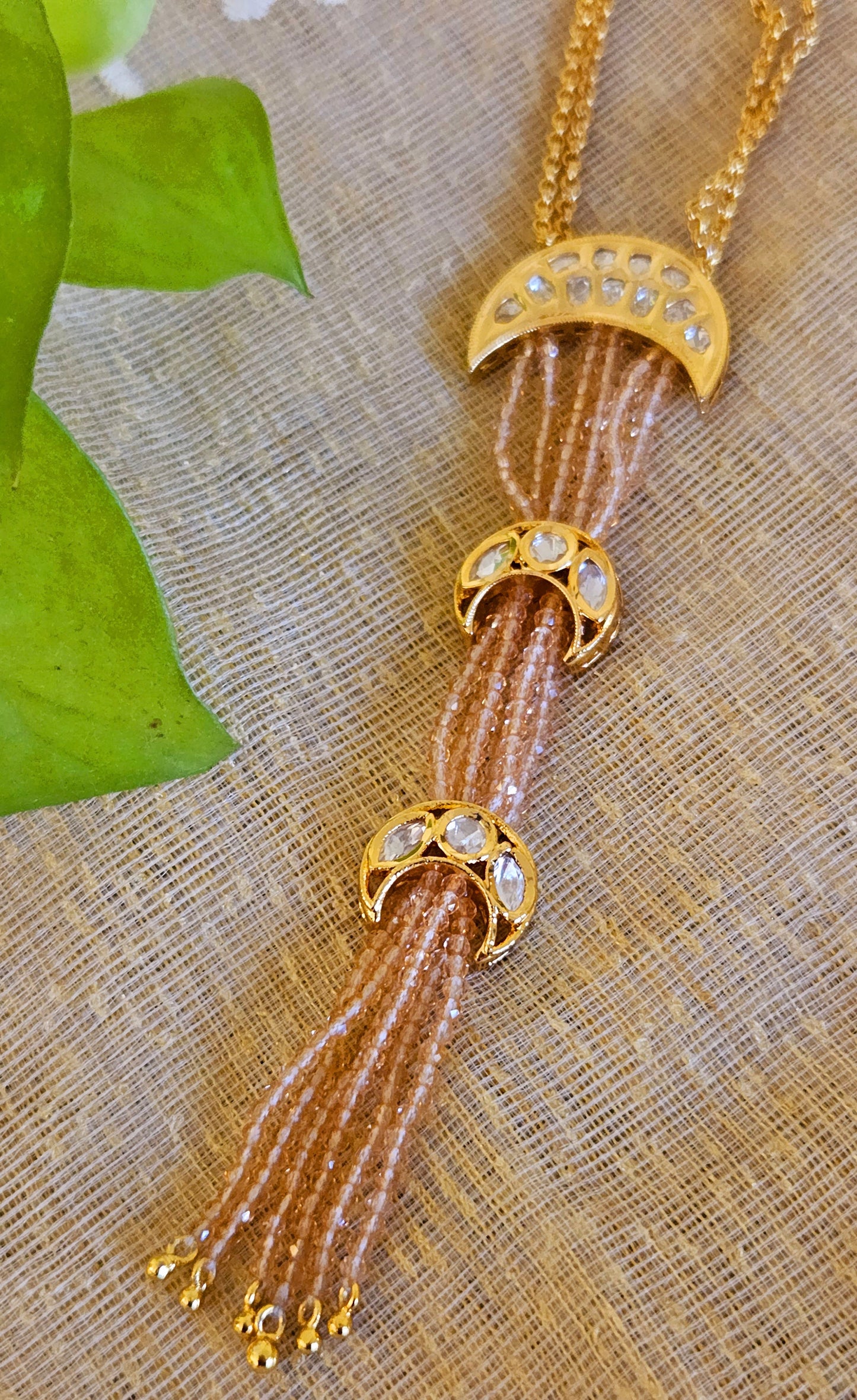 Neacklace with pale pink chain and three crescent kundan tikdas