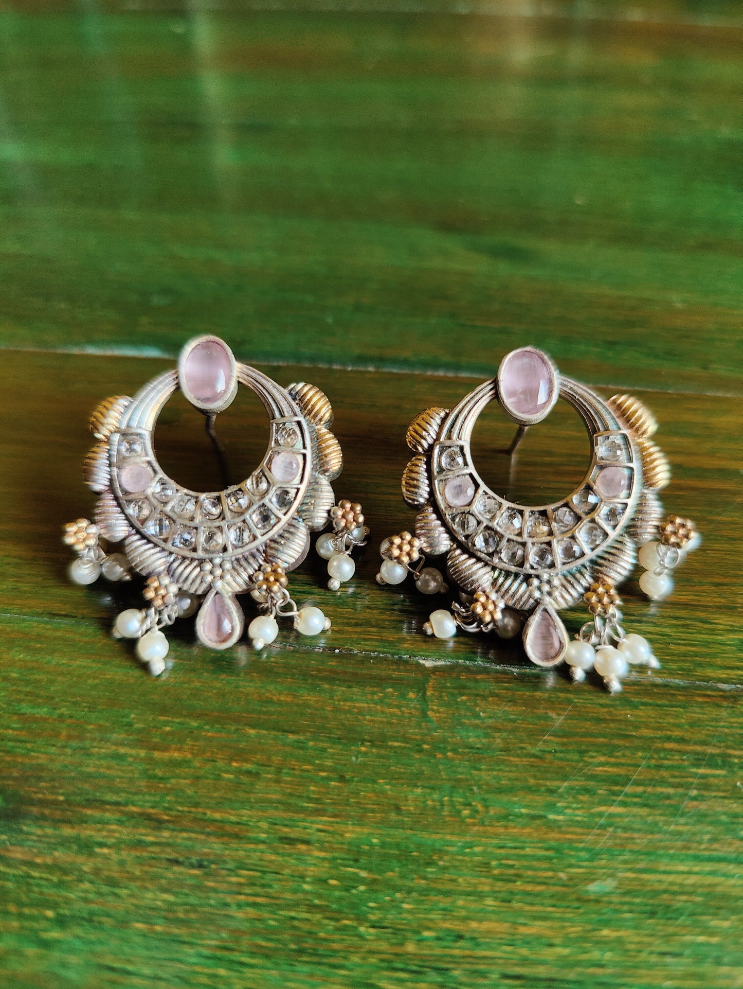 Dual tone finish set with hasli style necklace, peacock motif and mint green/pale pink stone inlay, matching earrings
