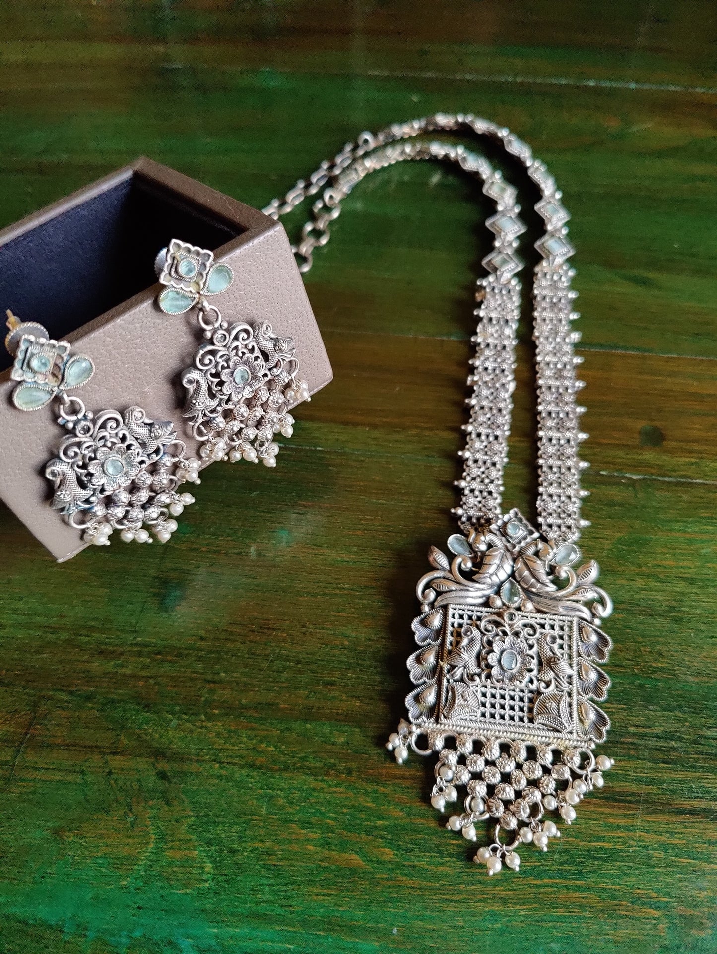 Silver finish set, long necklace with intricate work and pale pink/mint green detailing, matching earrings