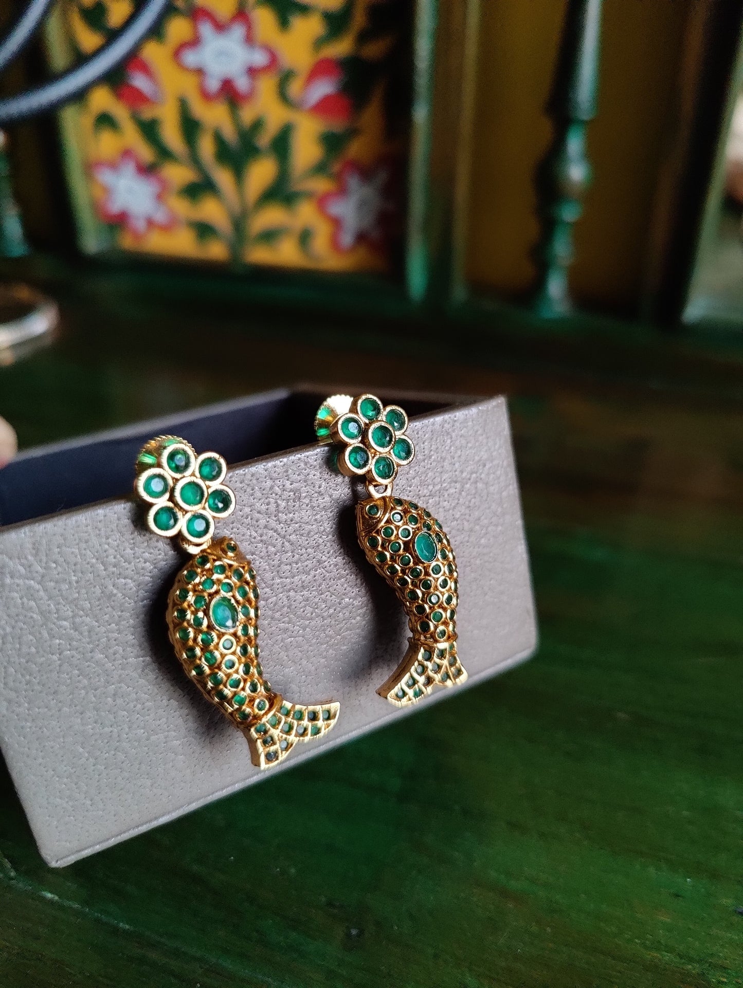 Gold finish fish motif reversible set with navratan stones on one side and emerald green/blue sapphire/ Ruby red stone inlay, matching earrings