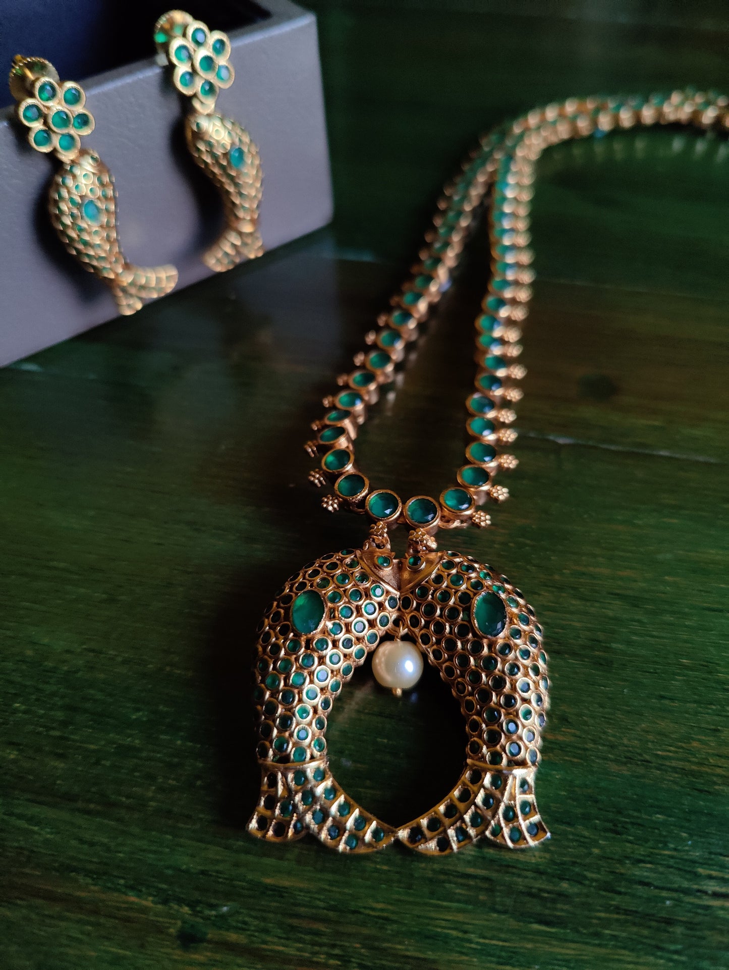 Gold finish fish motif reversible set with navratan stones on one side and emerald green/blue sapphire/ Ruby red stone inlay, matching earrings
