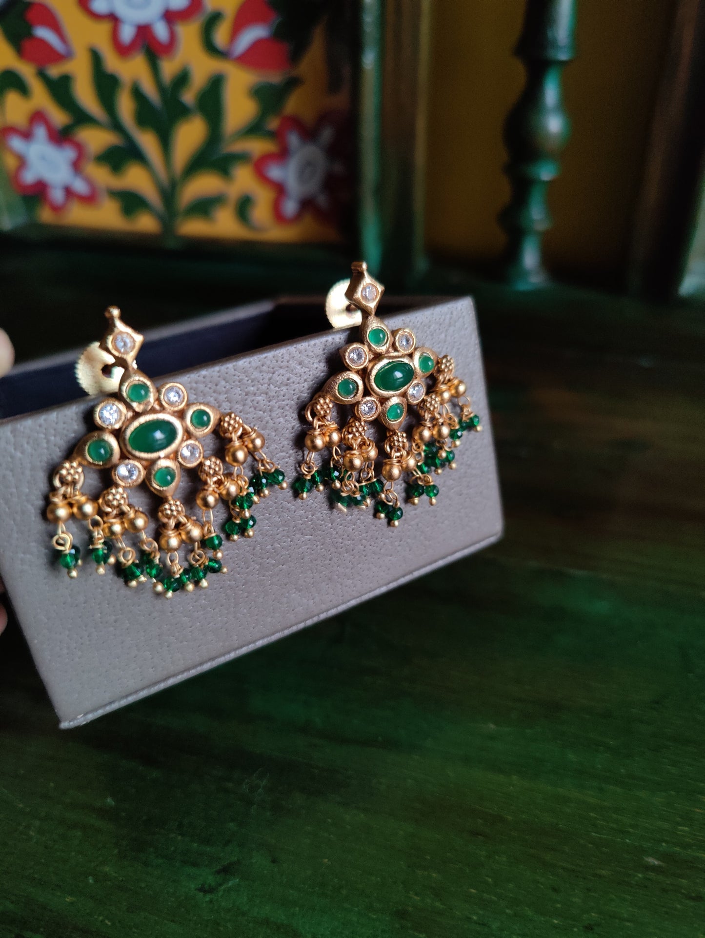 Gold finish set with deep pink/green and clear stone inlay, matching earrings