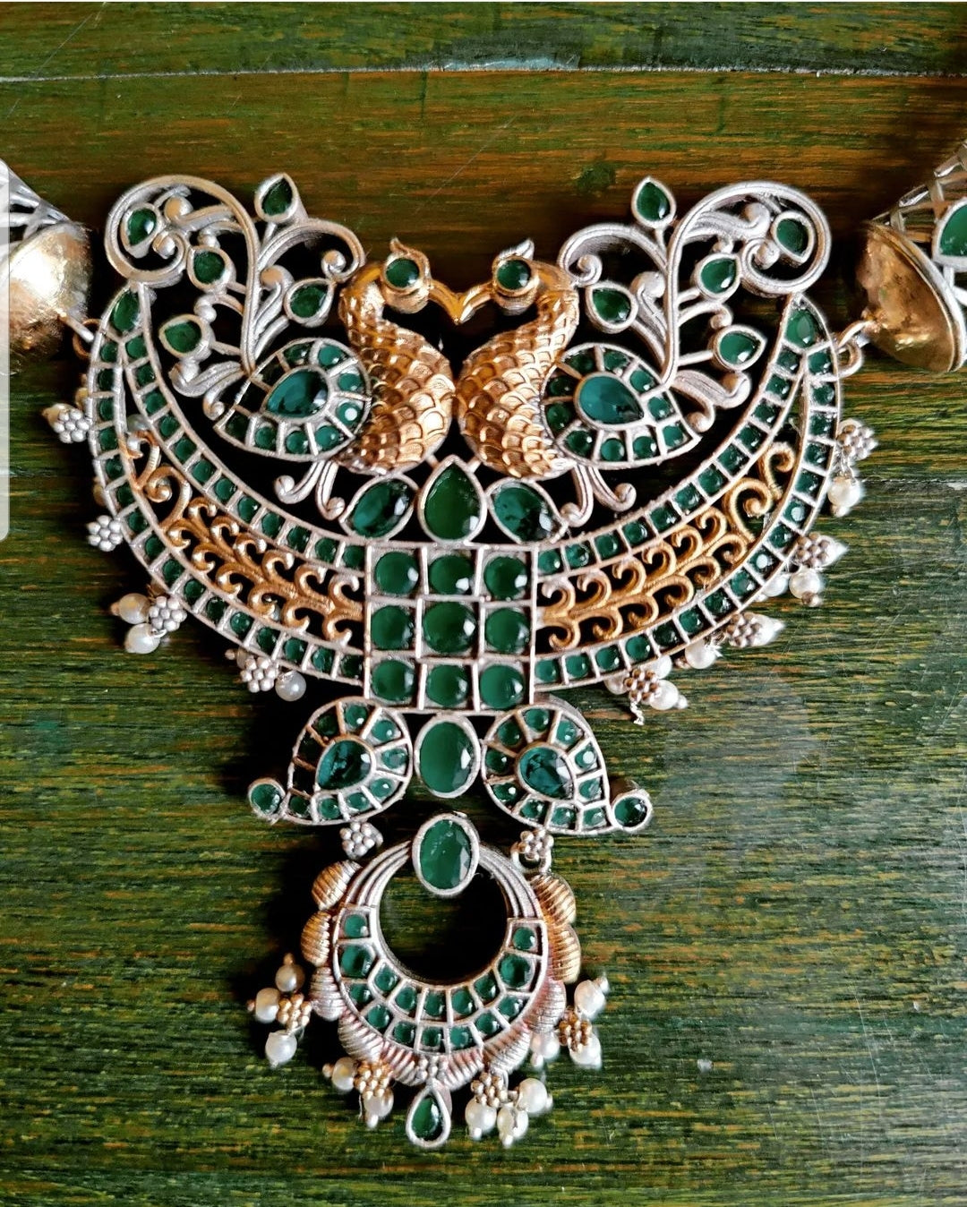 Dual tone finish set with hasli style necklace, peacock motif and mint green/pale pink stone inlay, matching earrings