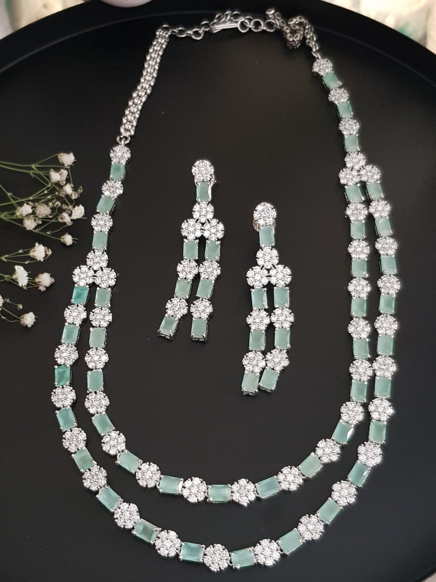 Platinum finish set,dual layered necklace with mint green stone and CZ flower,matching danglers (earrings)