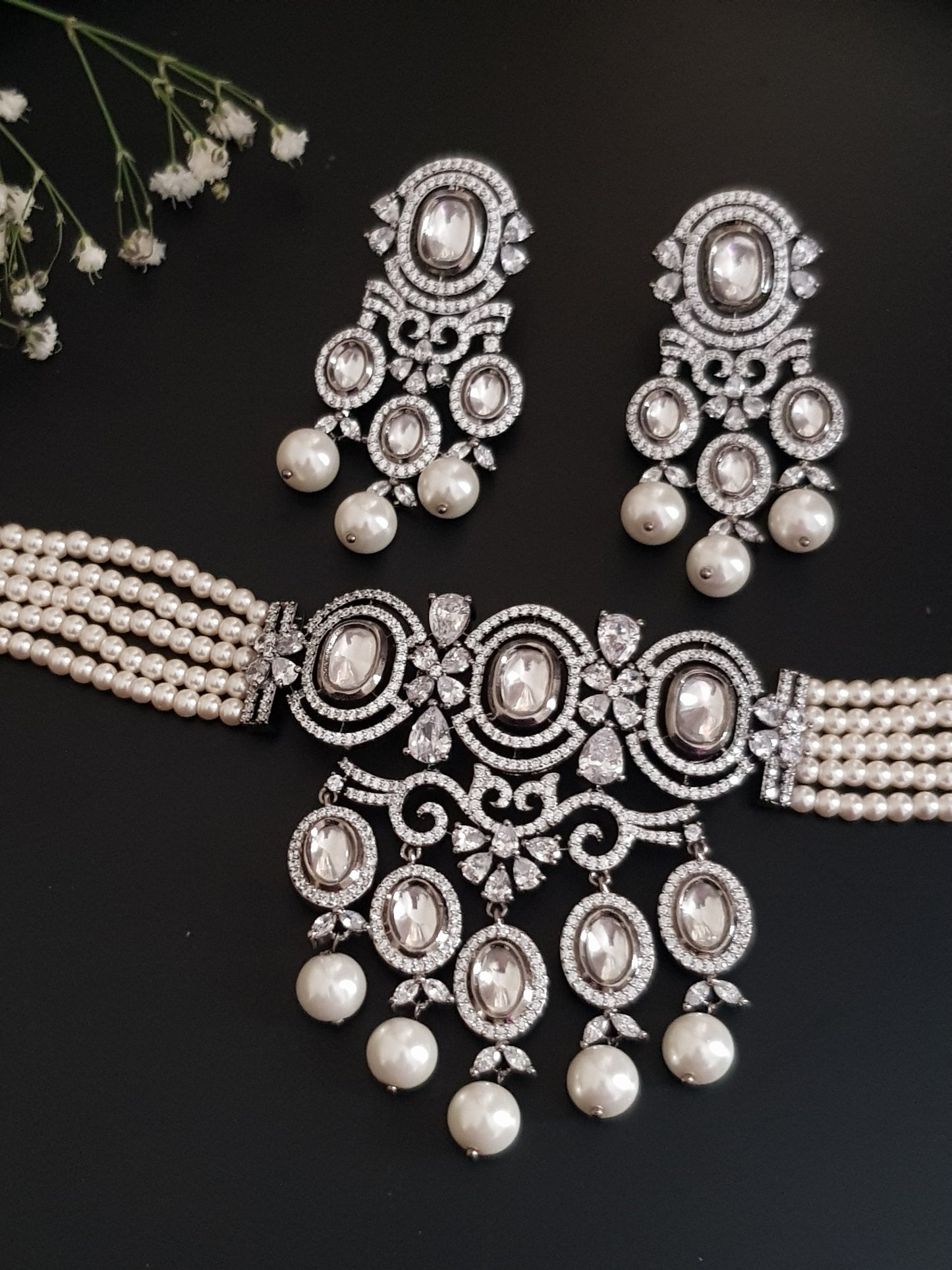 Platinum finish choker set,kundan and CZ detailing with big pearl drops , matching earrings