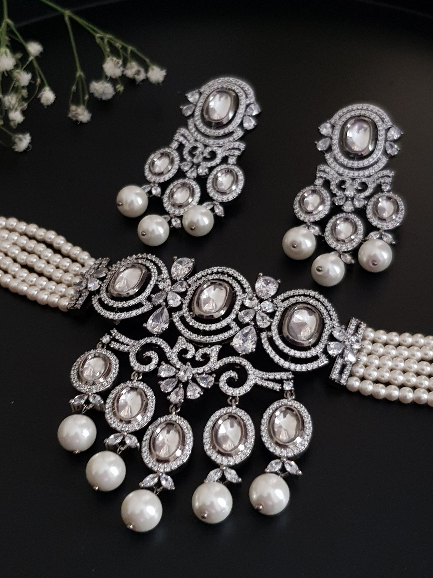 Platinum finish choker set,kundan and CZ detailing with big pearl drops , matching earrings