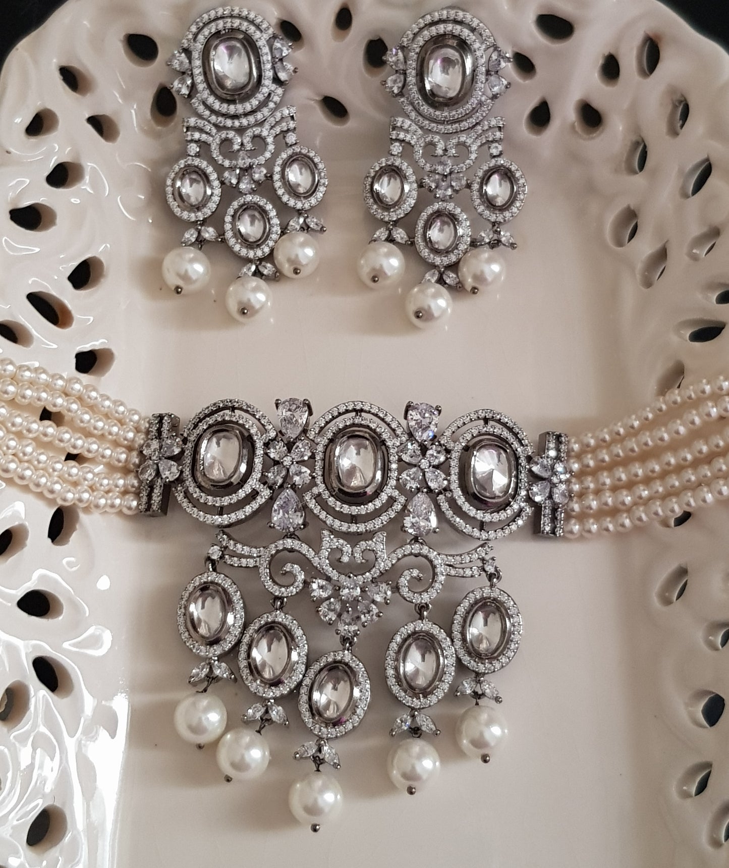 Platinum finish choker set,kundan and CZ detailing with big pearl drops , matching earrings