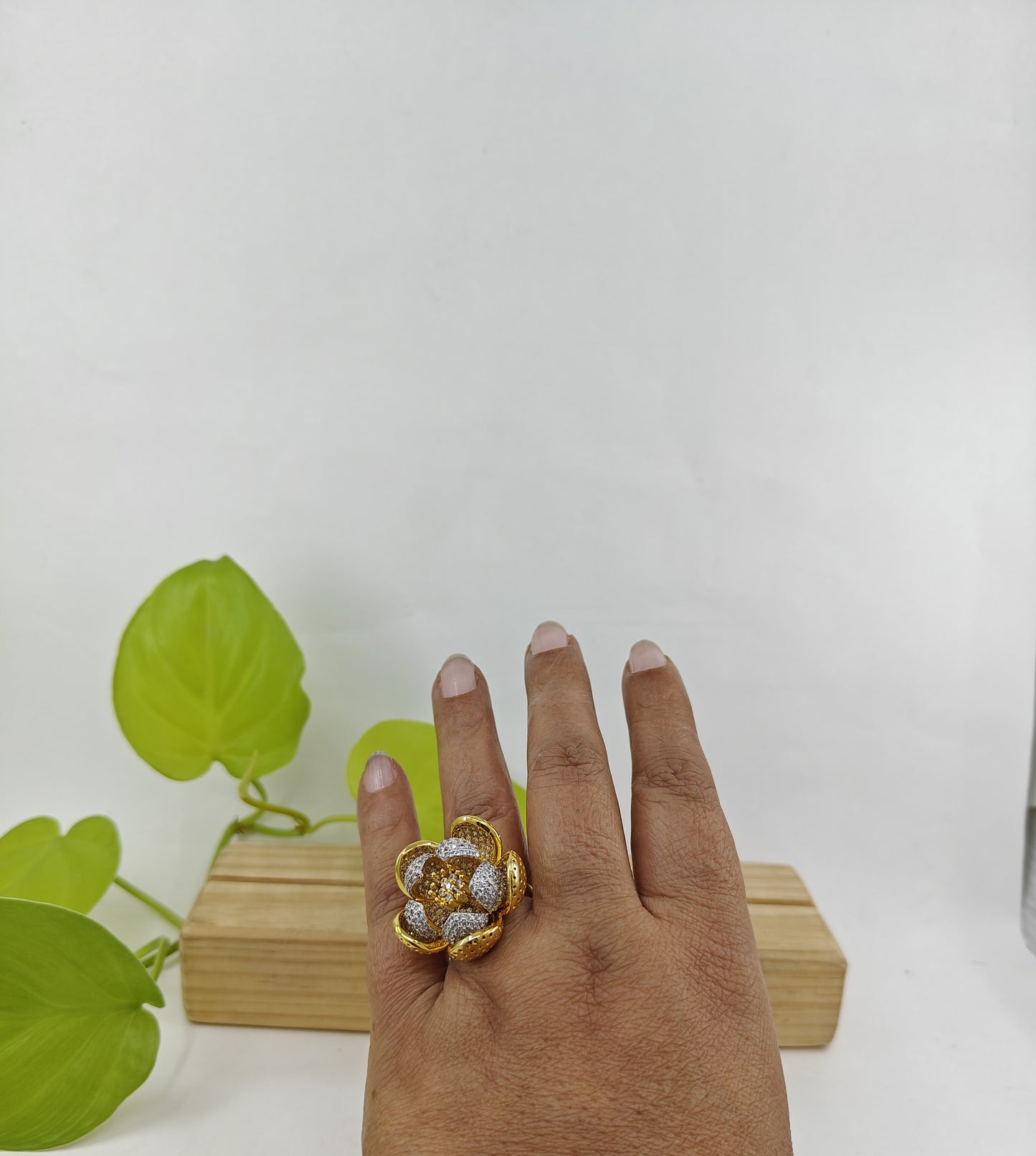 Dual tone ring with an open flower design with silver and gold finish petals