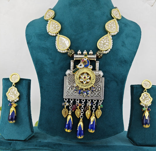 A dual tone set with Thewa work, pendant with pearched stone work peacock, meenakari hangings