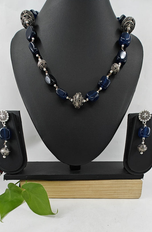 Set in black stone and jali beads