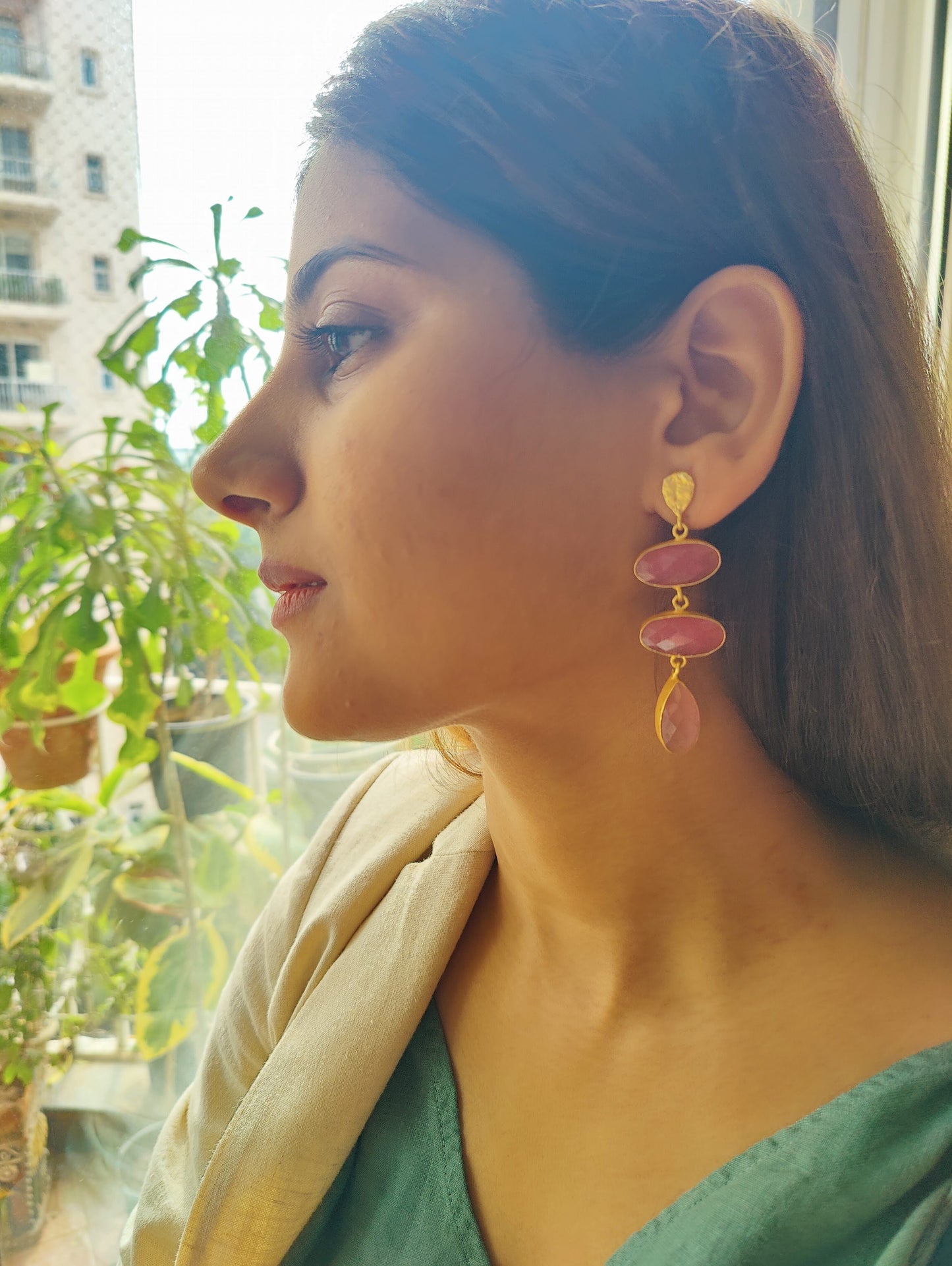 Hanging earrings in a golden frame with stones.