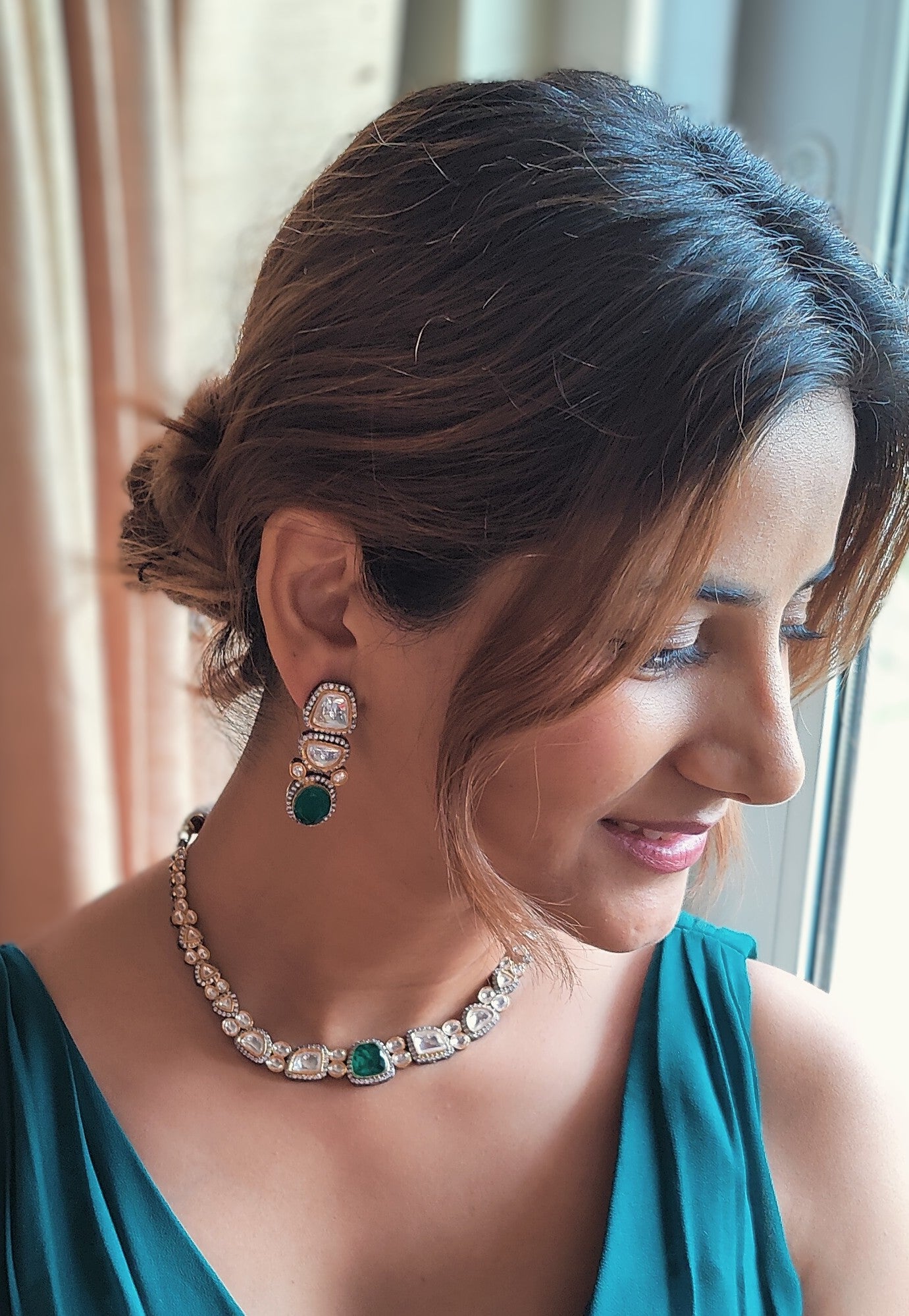 Eesha set in moissanite and emerald green stone