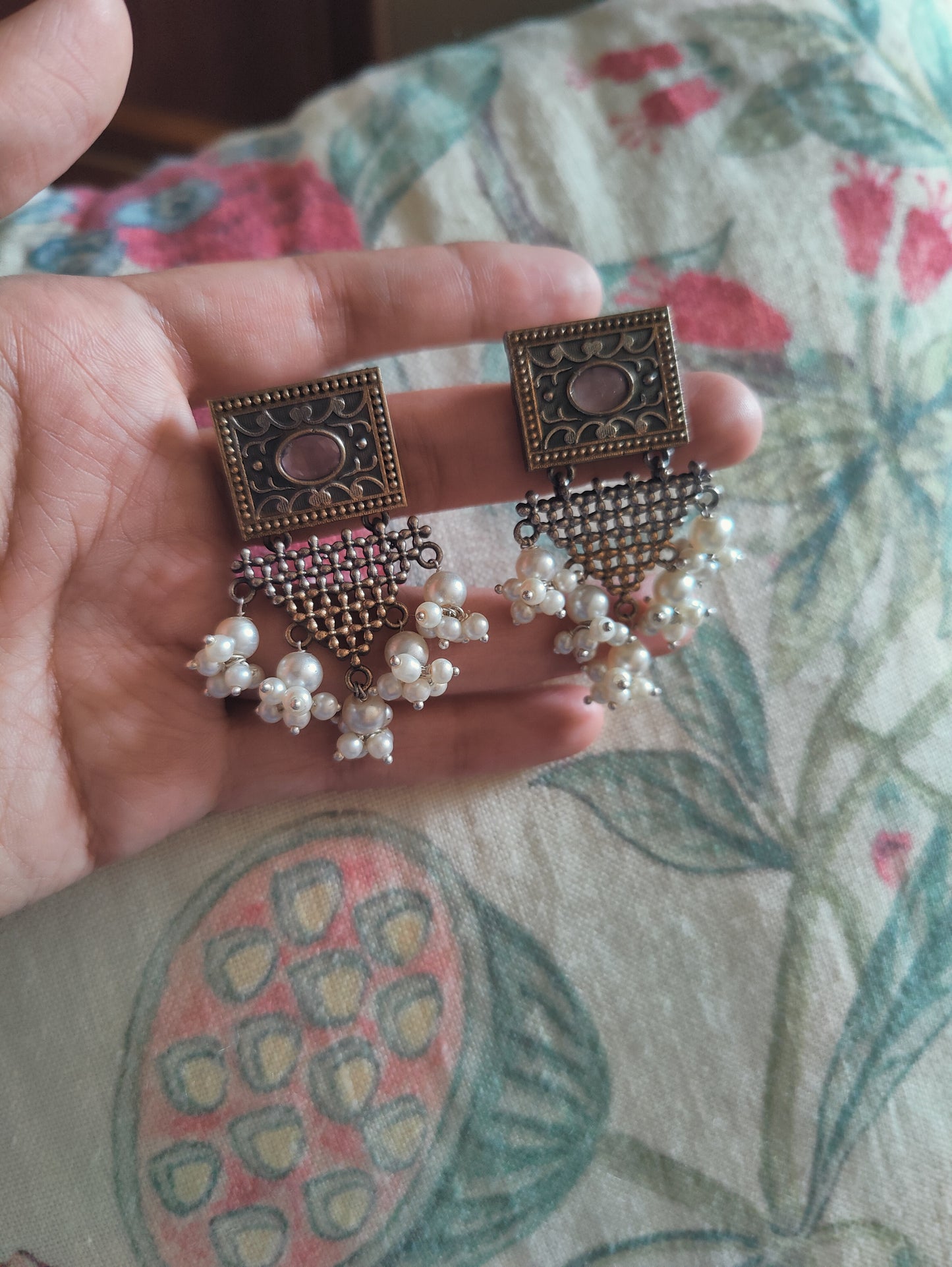 Earrings in dual tone with triangular hangings with pearls