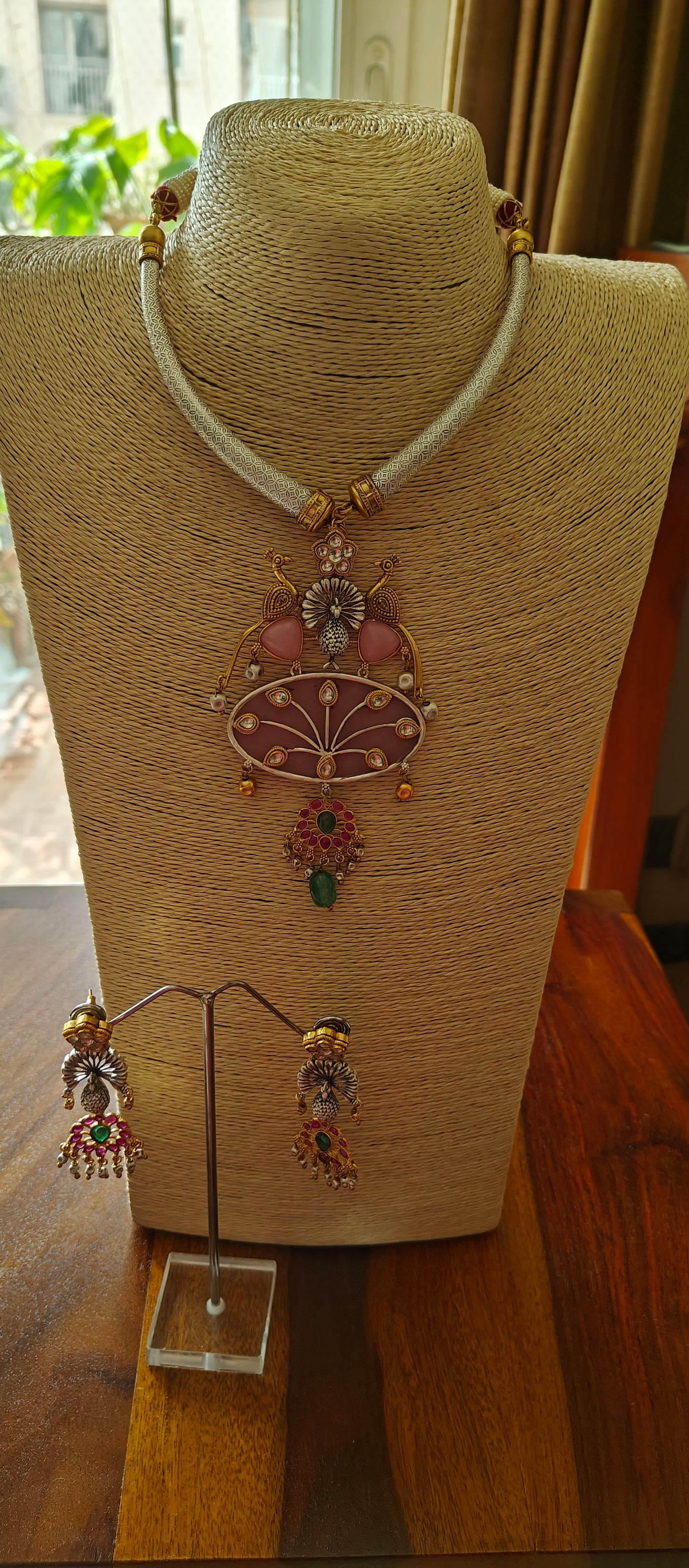 Hasli set in dual tone, pearched peacocks on stone pendant with Kundan work, matching earrings