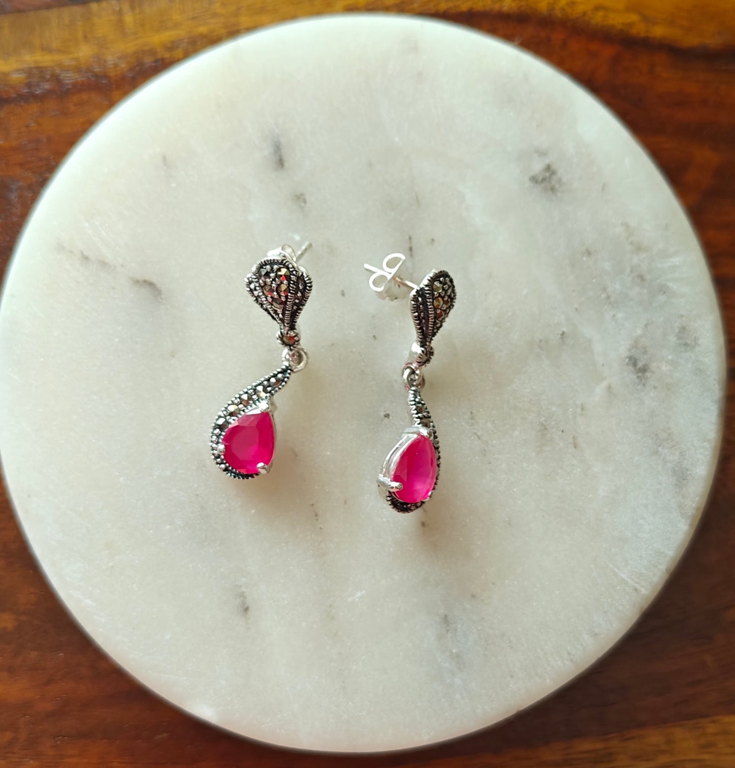 Silver earrings with ruby red stone