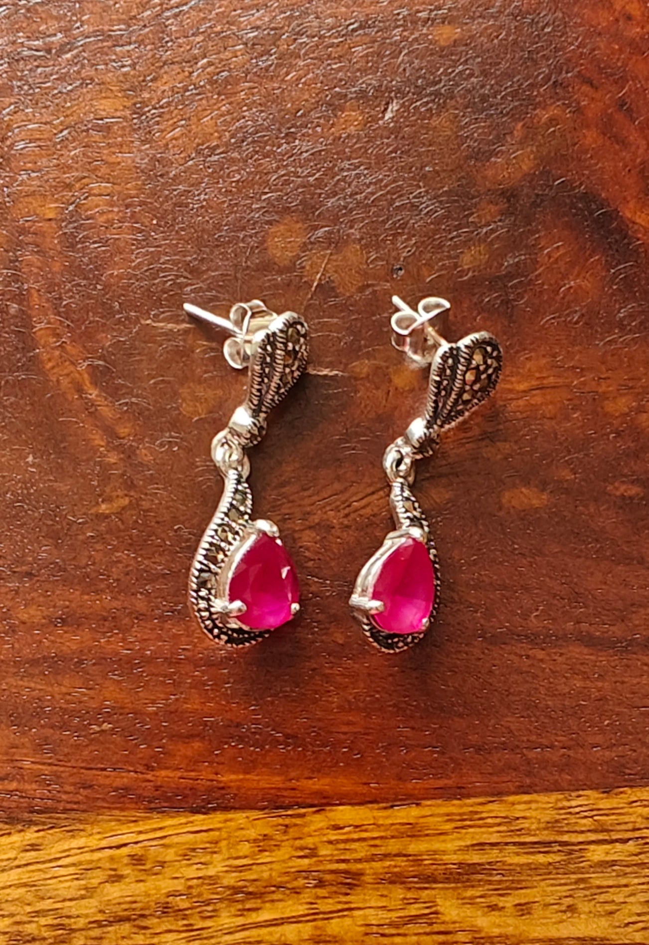 Silver earrings with ruby red stone