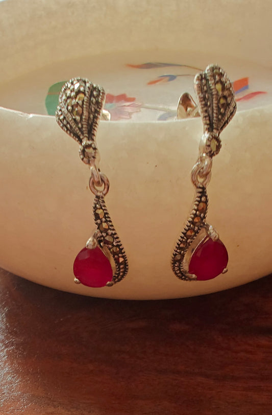 Silver earrings with ruby red stone