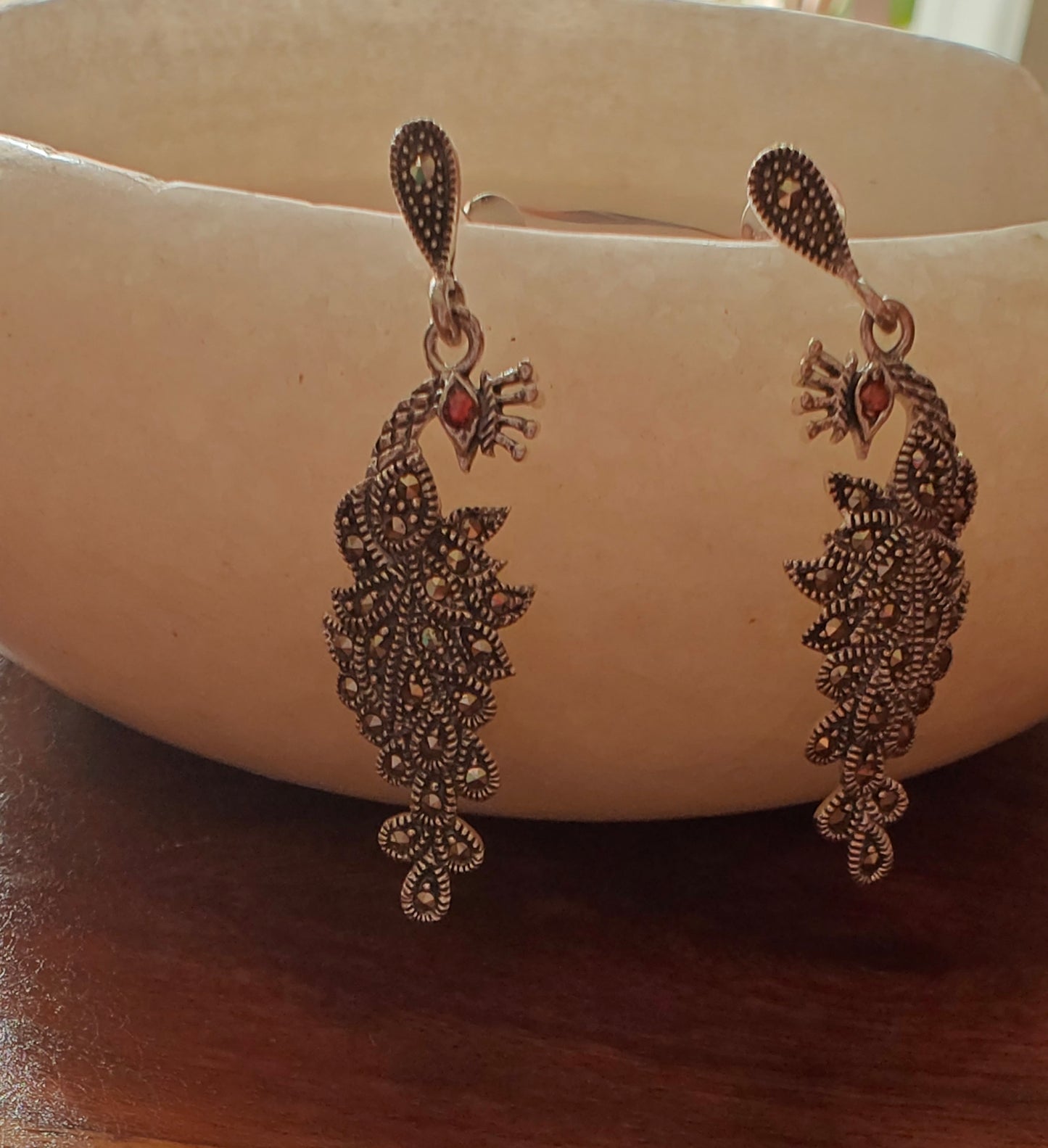 Silver peacock earrings with red stone eye