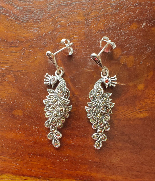 Silver peacock earrings with red stone eye