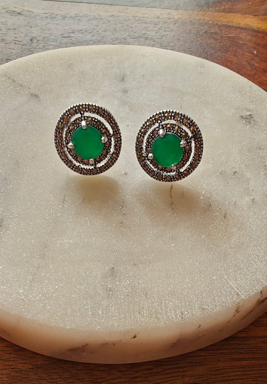 Radial silver studs with emerald green/ ruby pink stone