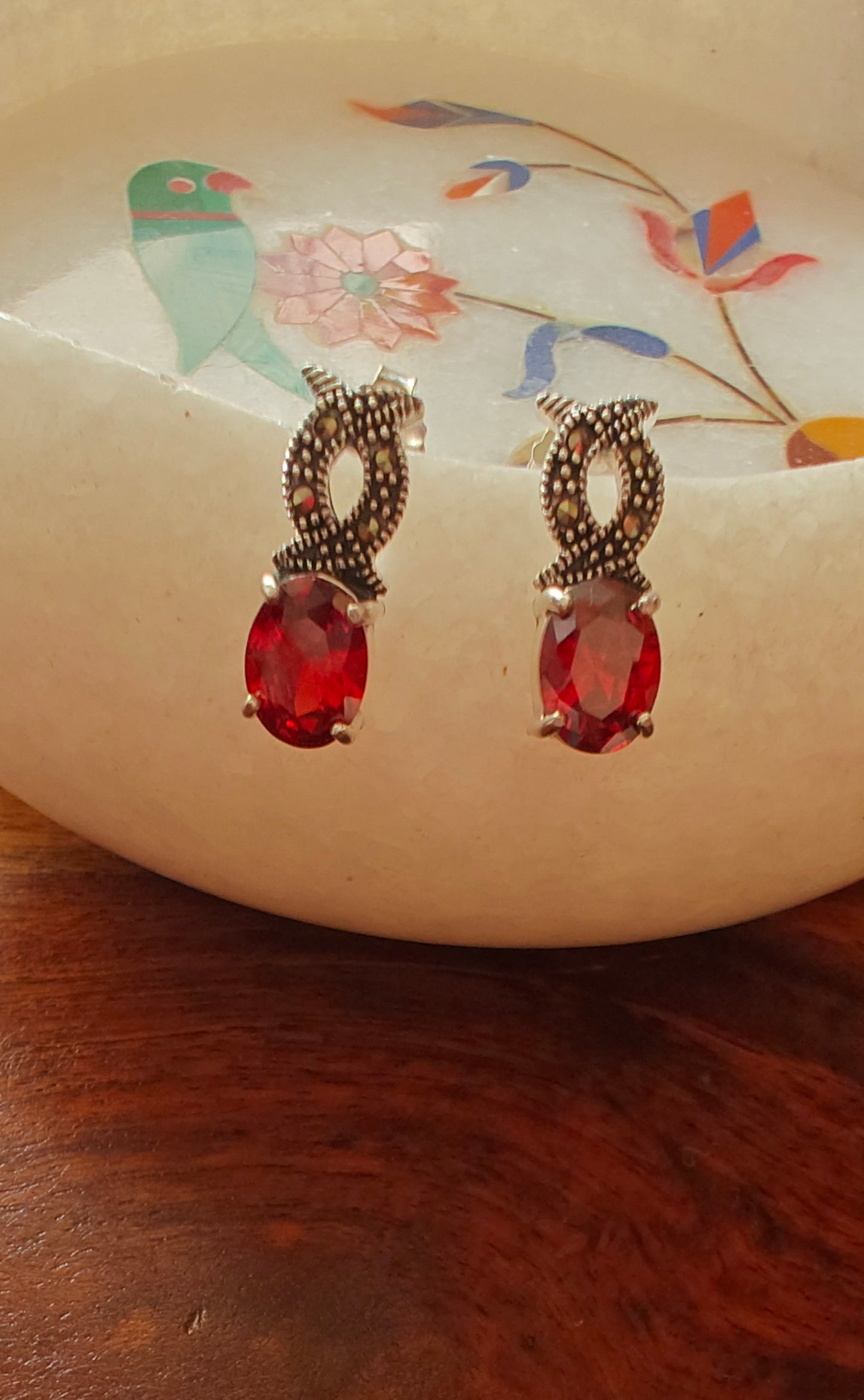 Silver infinity earrings with ruby red stone