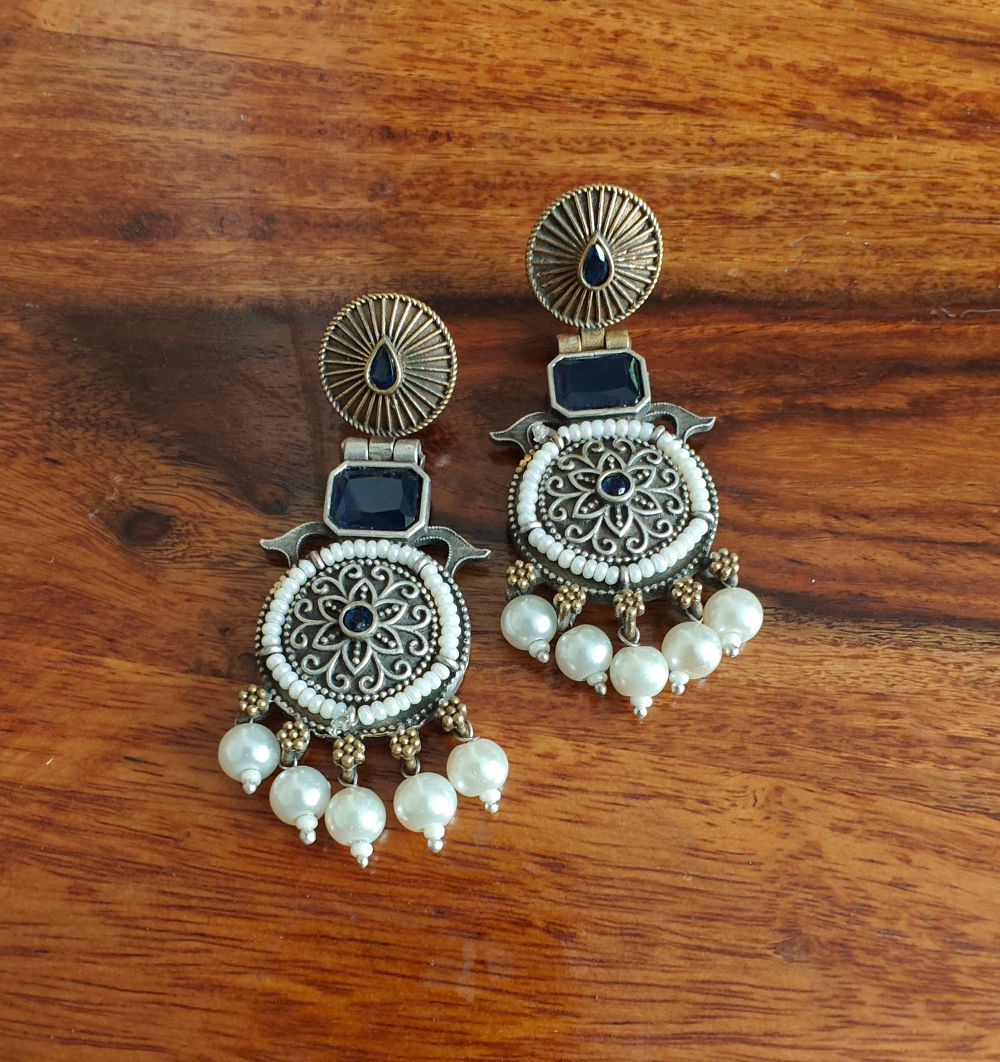 Dual tone earrings with stone and pearl edging