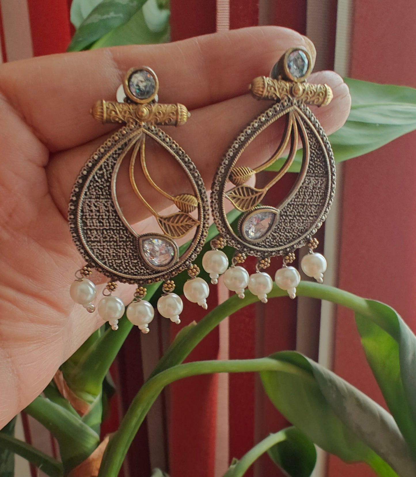 Dual tone earrings with coloured stone with petals in centre